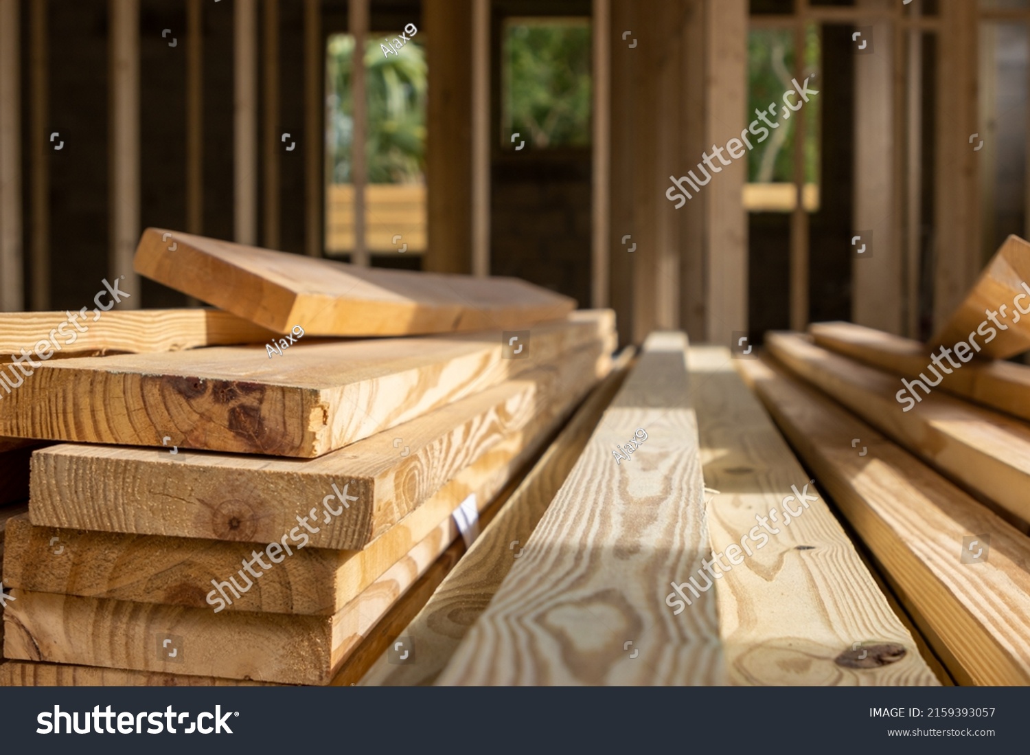 Pile of wood lumber planks stacked at residential construction site #2159393057