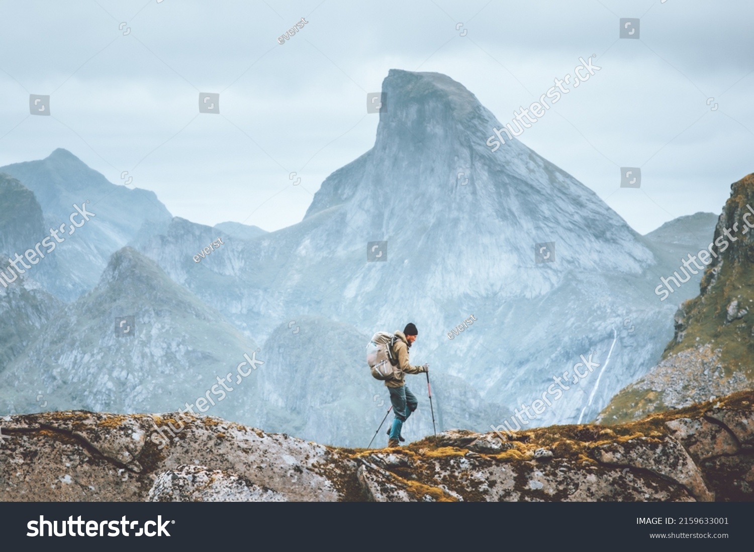 Man hiking in mountains traveling solo with backpack outdoor active vacations in Norway healthy lifestyle extreme sports #2159633001