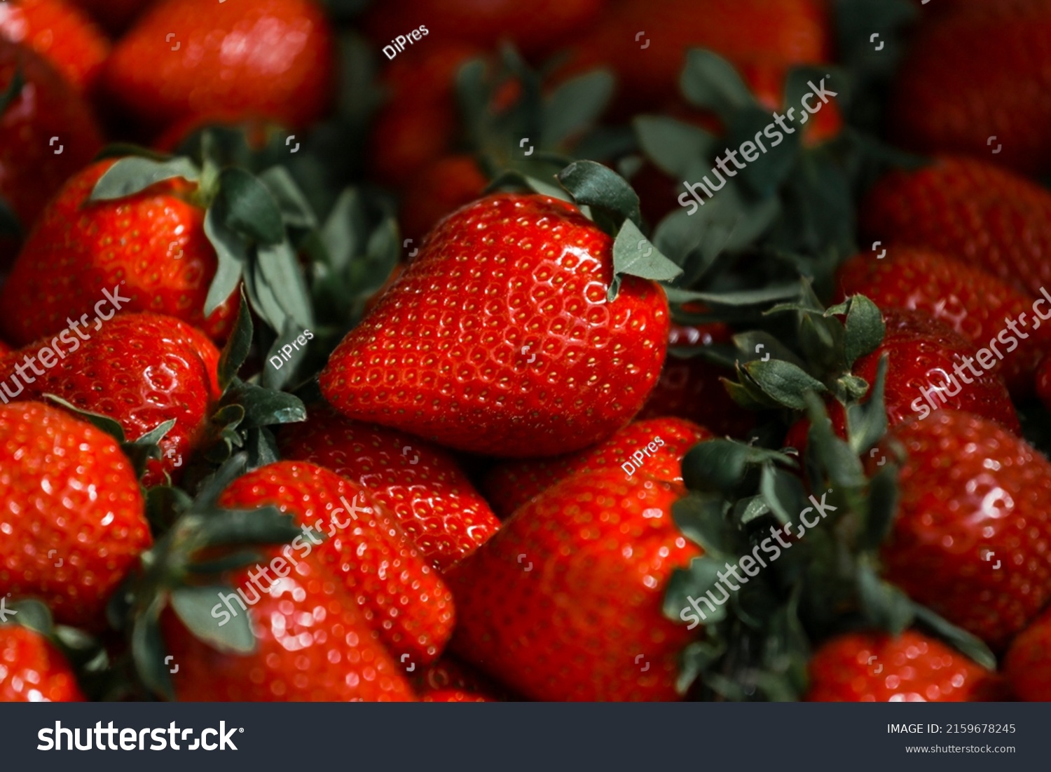 Close-up of a selective focus of ripe strawberries on the counter. Strawberries are sold in boxes as a healthy food. Top view of delicious, fresh, juicy strawberries, just picked. Juicy berries. #2159678245
