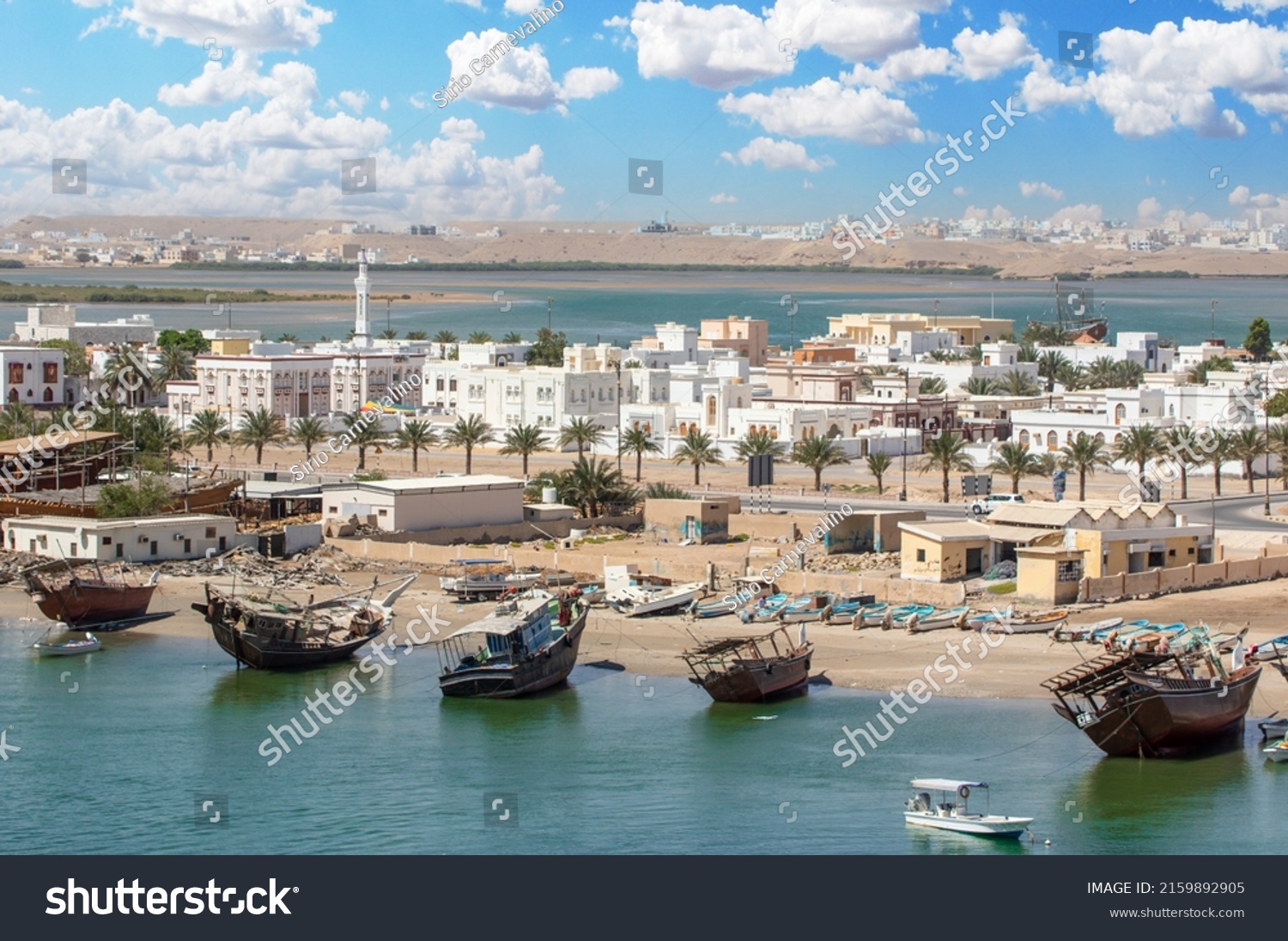 Sur, Oman - an important point for sailors and famous also for its building wooden ships, Sur is a pearl of Oman, with its fusion of green waters, white buildings and red rocks #2159892905