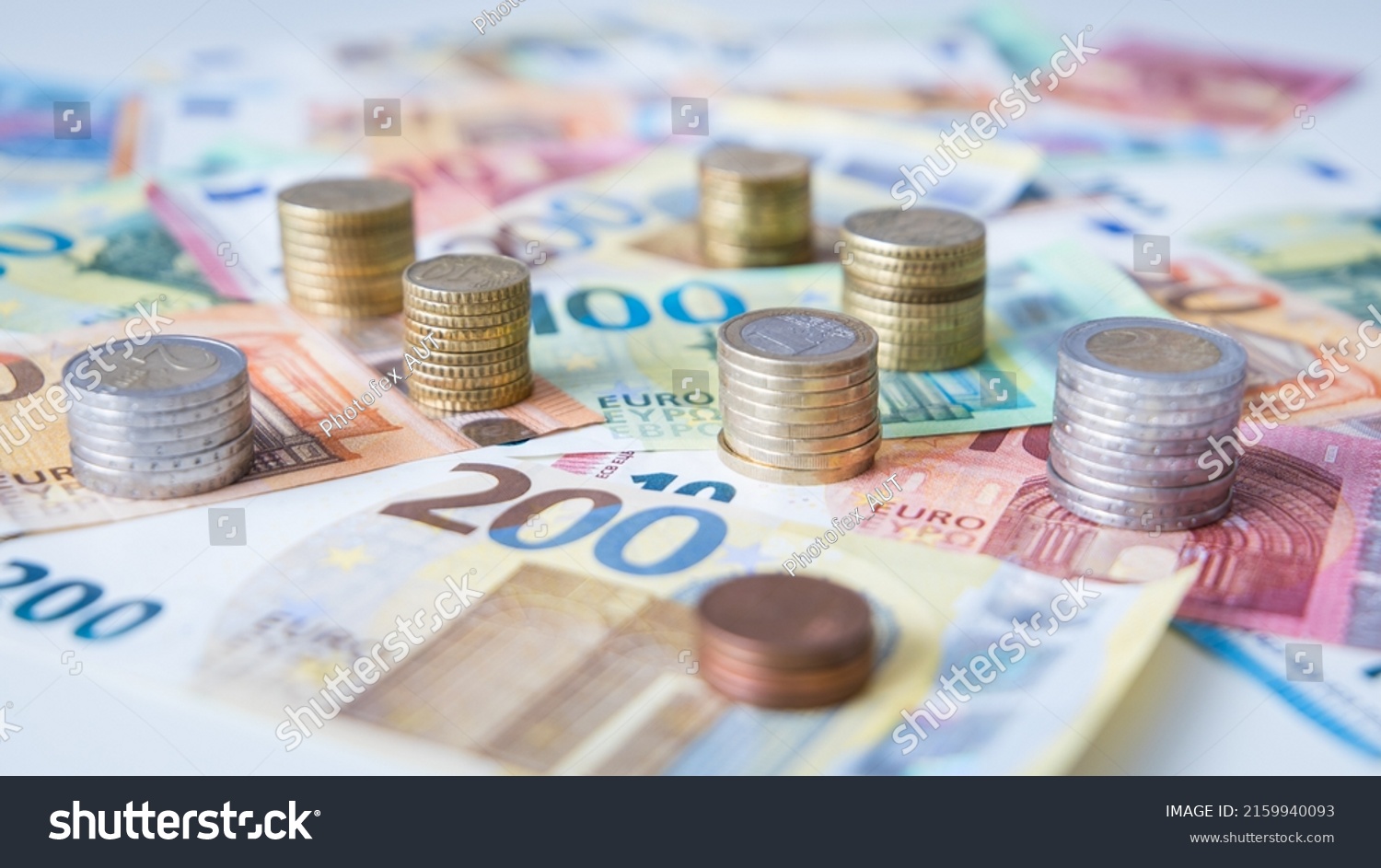 A combination of different Euro banknotes and Euro coins as a closeup #2159940093