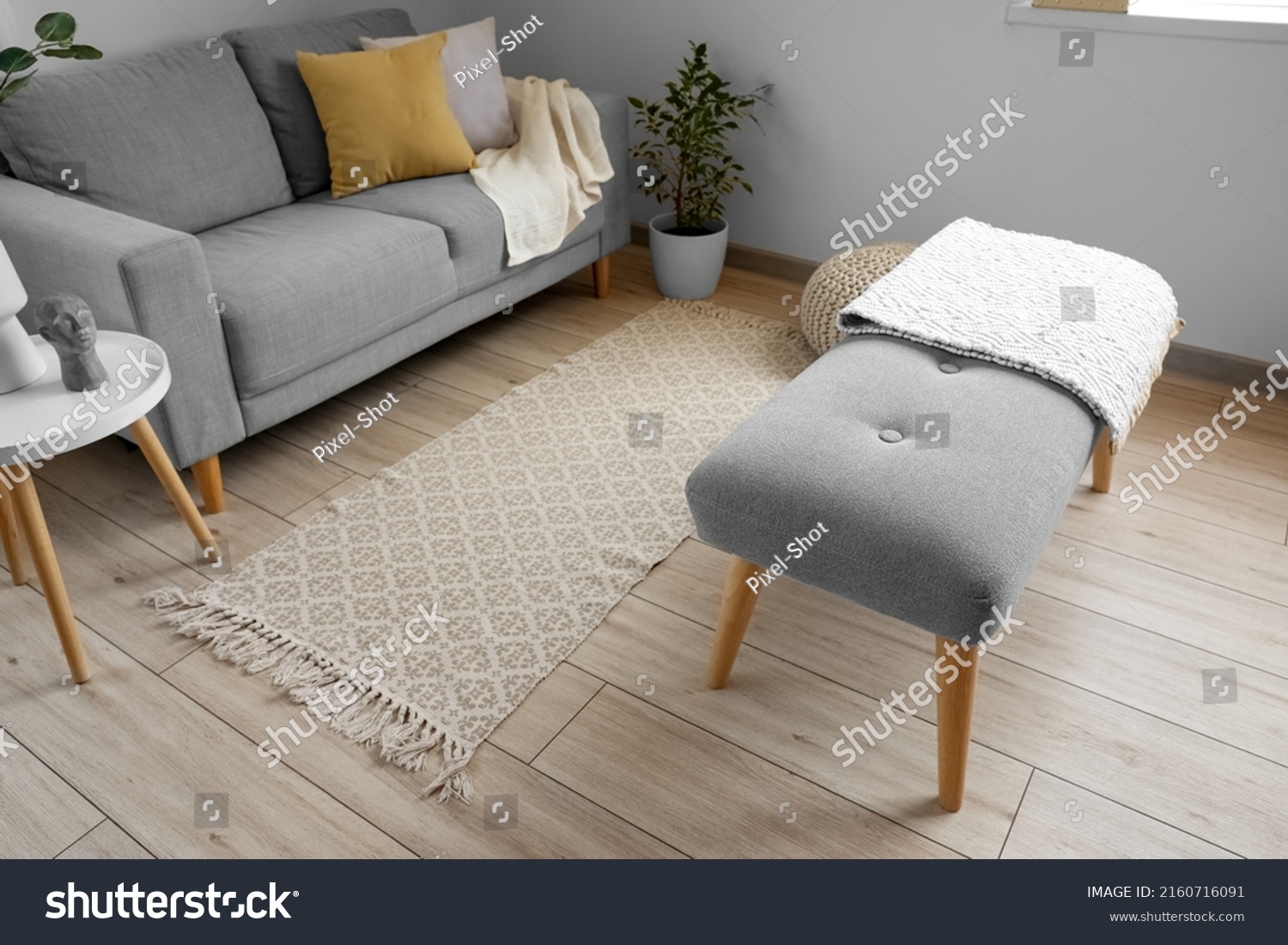 Soft bench with plaid in interior of light living room #2160716091