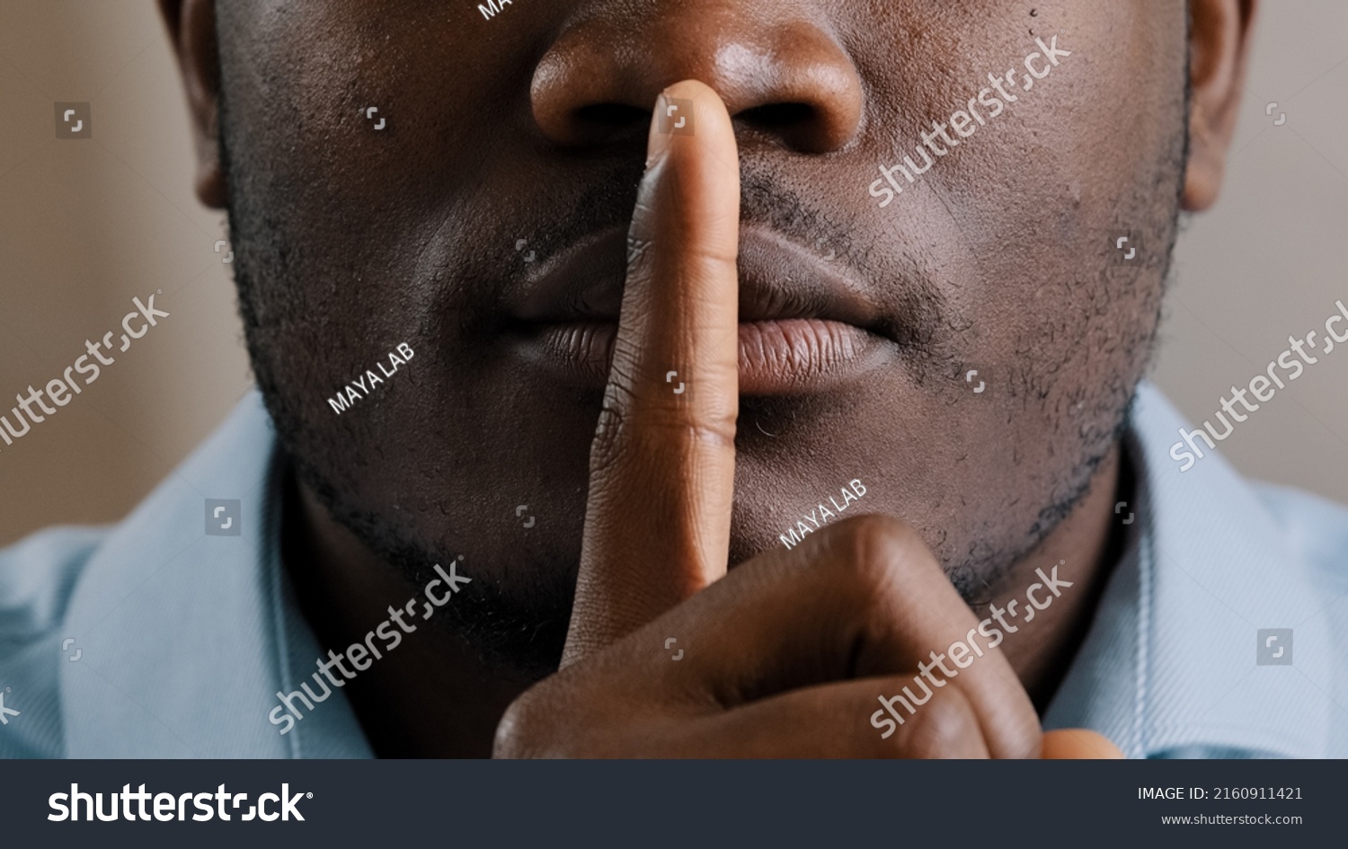 Mysterious unknown male face part african american adult man put finger to lips ask be quiet make gesture silence show secrecy sign keep secret confident information silent forbid tell close up view #2160911421