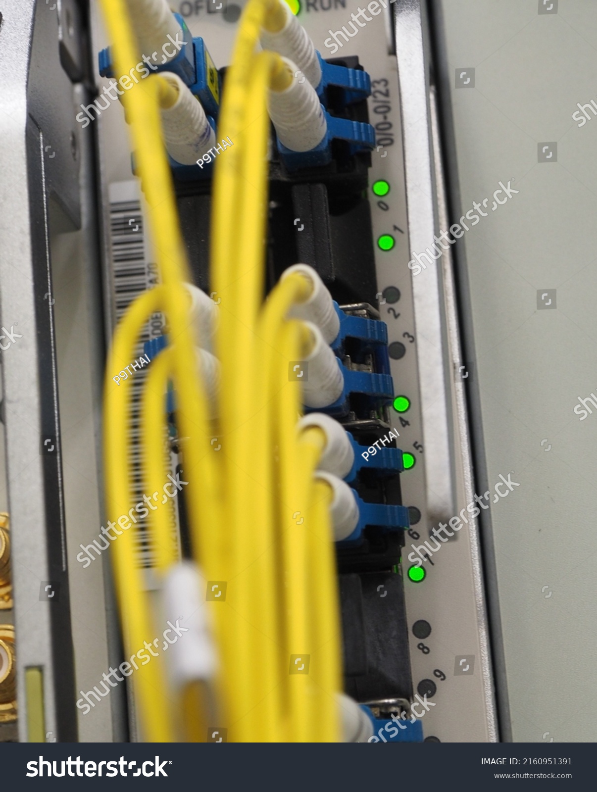 Fiber Optical data cables connected to an optic ports and Network cables connected to ethernet port and UTP Network cables  #2160951391