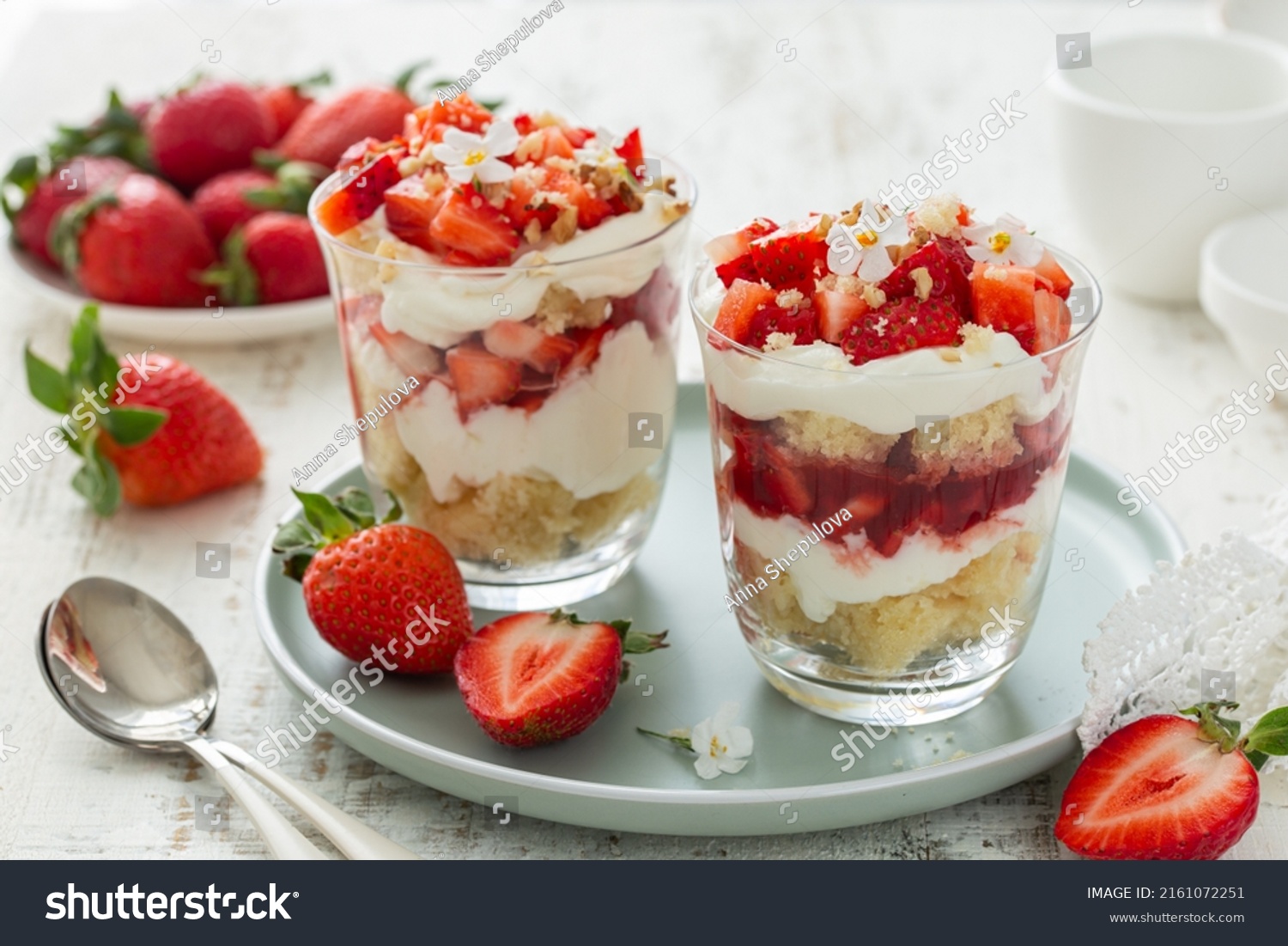 delicious strawberry vanilla cream dessert in glasses served with fresh berries, white background #2161072251