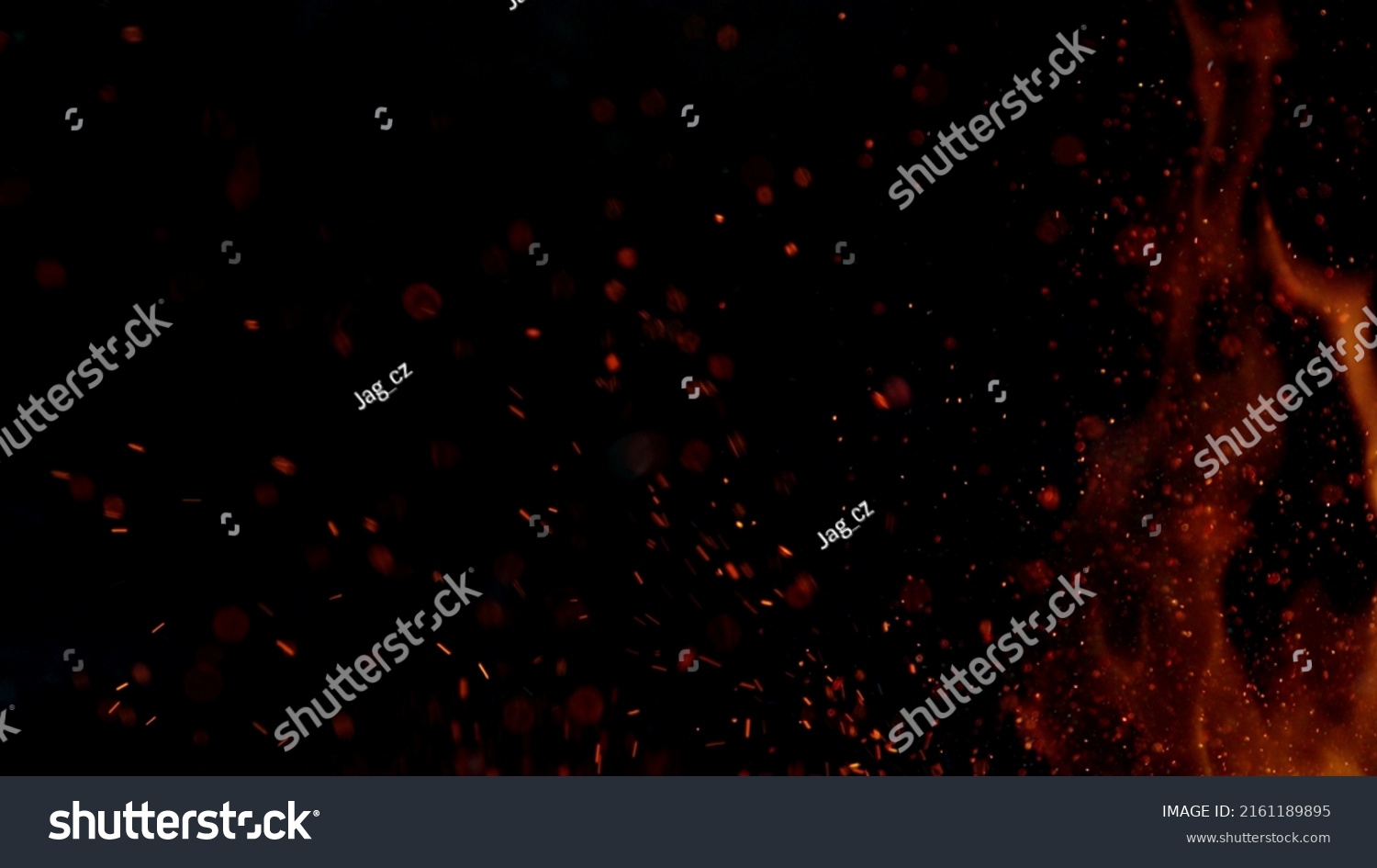 Fire sparks flying like particles on black background. Abstract background. #2161189895