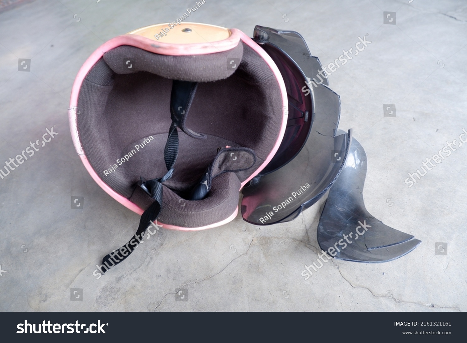 Broken helmet lying on the floor #2161321161
