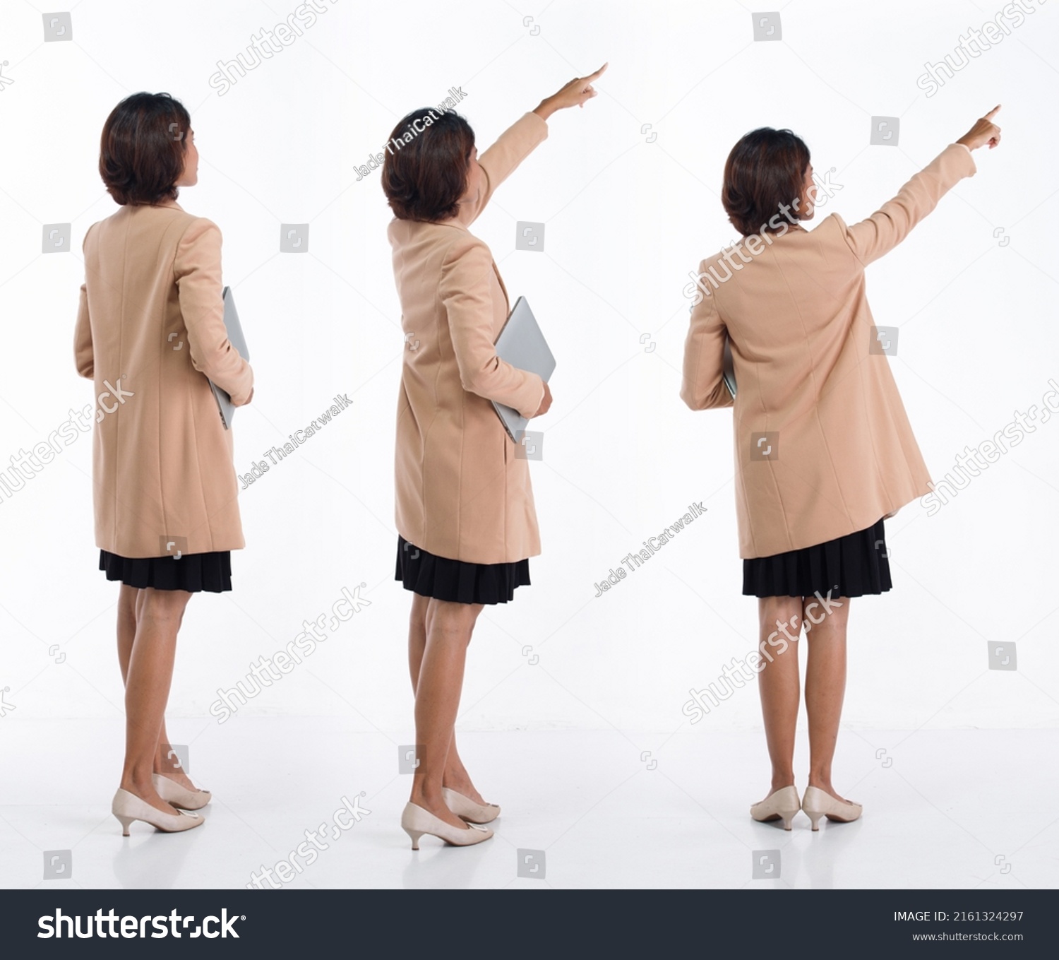 Full length 20s young Asian Business Woman businesswoman wear blazer skirt, pointing finger hand up. Office female carry laptop notebook coffee cup happy smile over white background isolated #2161324297