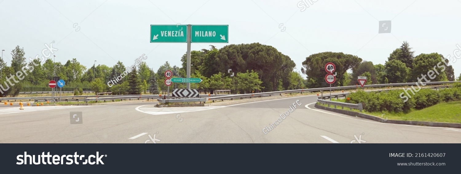motorway junction with the Italian indications for the city of VENICE on the LEFT or MILAN if you turn RIGHT without cars #2161420607