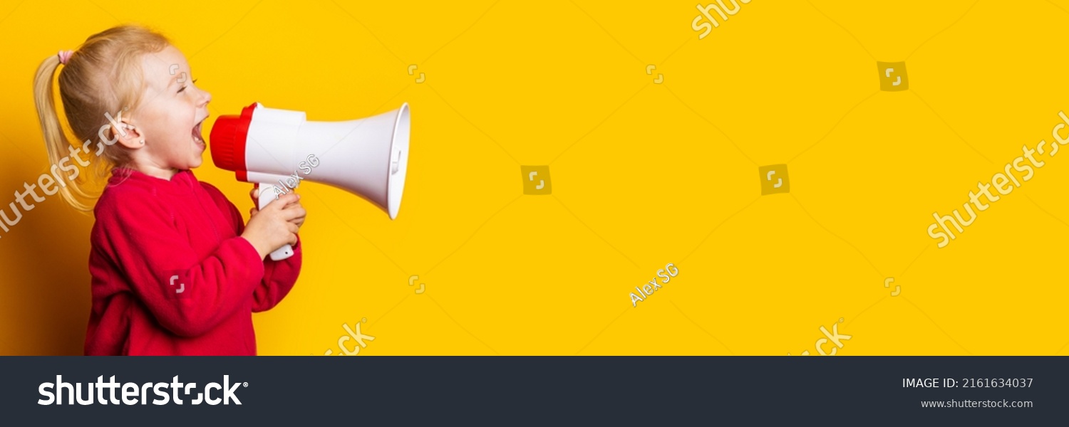 child girl shouts into a white megaphone on a bright yellow background. Banner. #2161634037