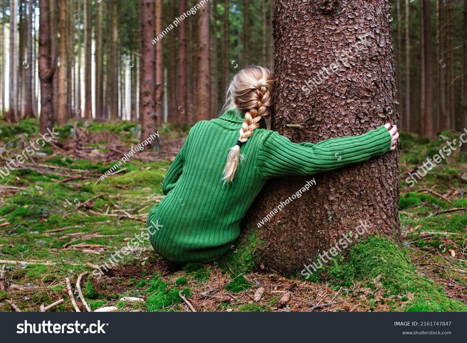 Woman sitting in forest and enjoys beauty of nature. #2161747847