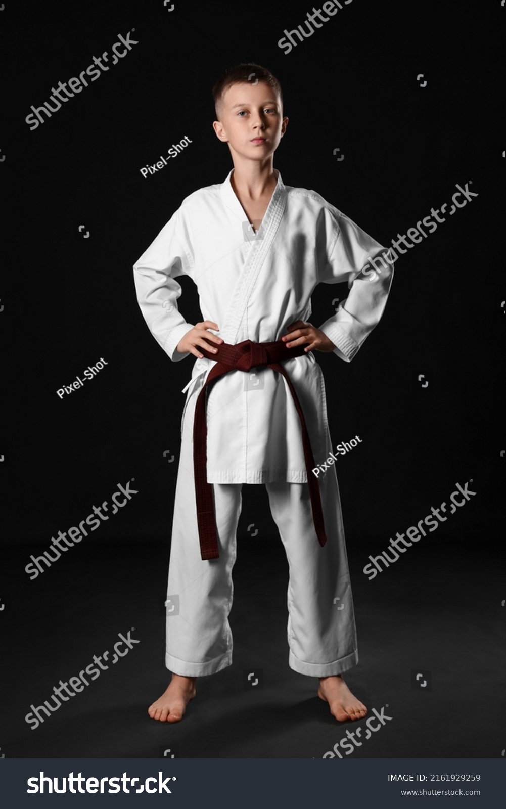 Boy in karategi on black background #2161929259