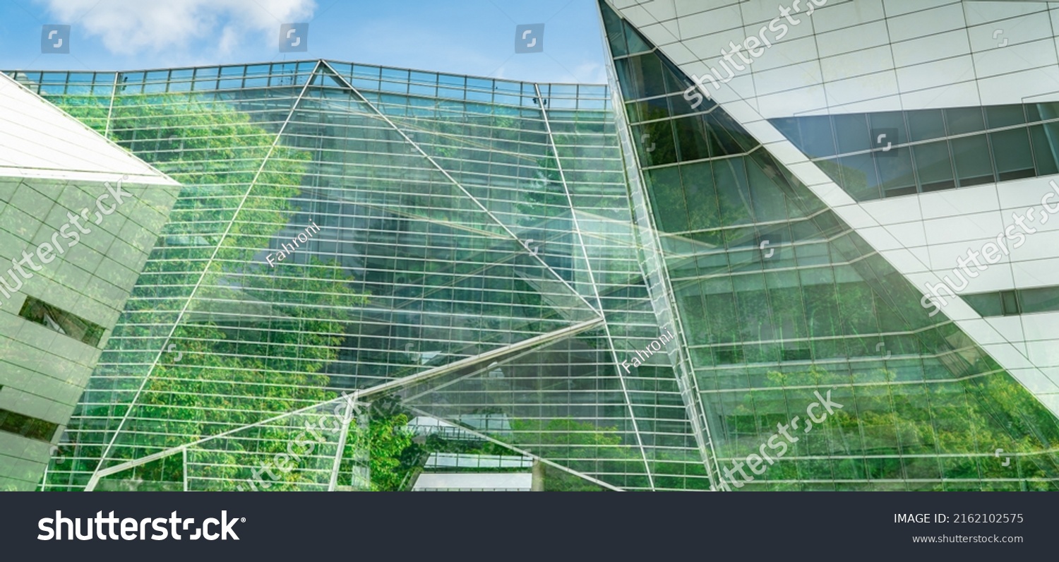 Eco-friendly building in the modern city. Sustainable glass office building with tree for reducing heat and carbon dioxide. Office building with green environment. Corporate building reduce CO2. #2162102575