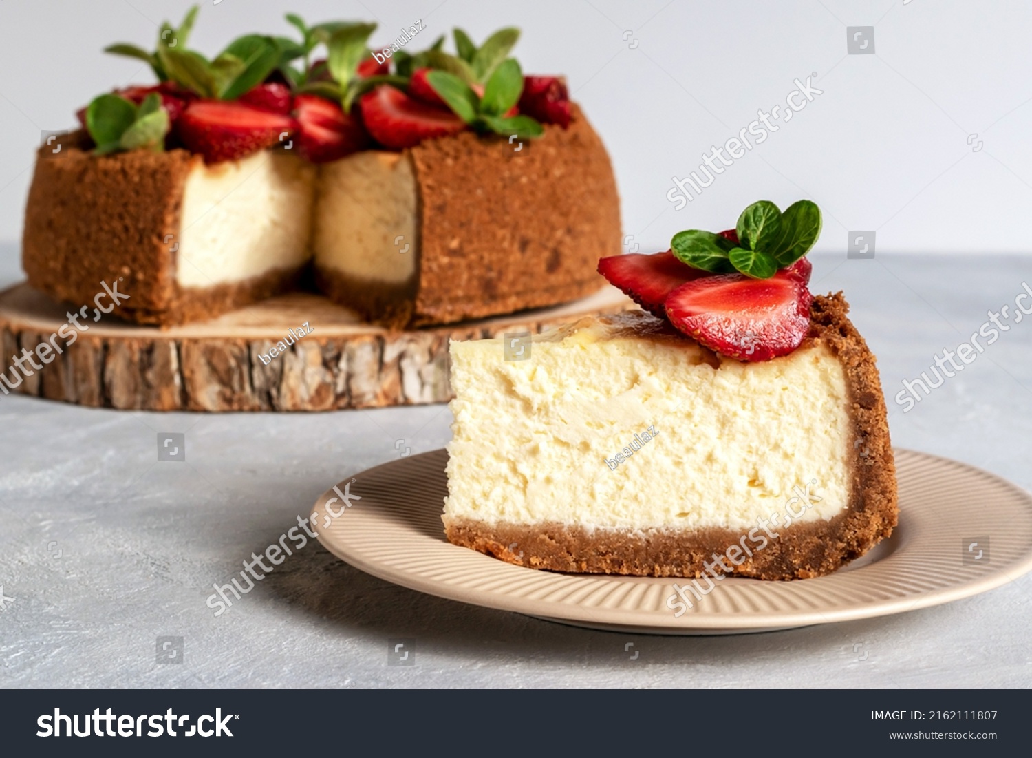New York cheesecake is a dessert that is an open pie or even a cake. Decorated with strawberries. It consists of two main parts: sand base and cheese filling. #2162111807
