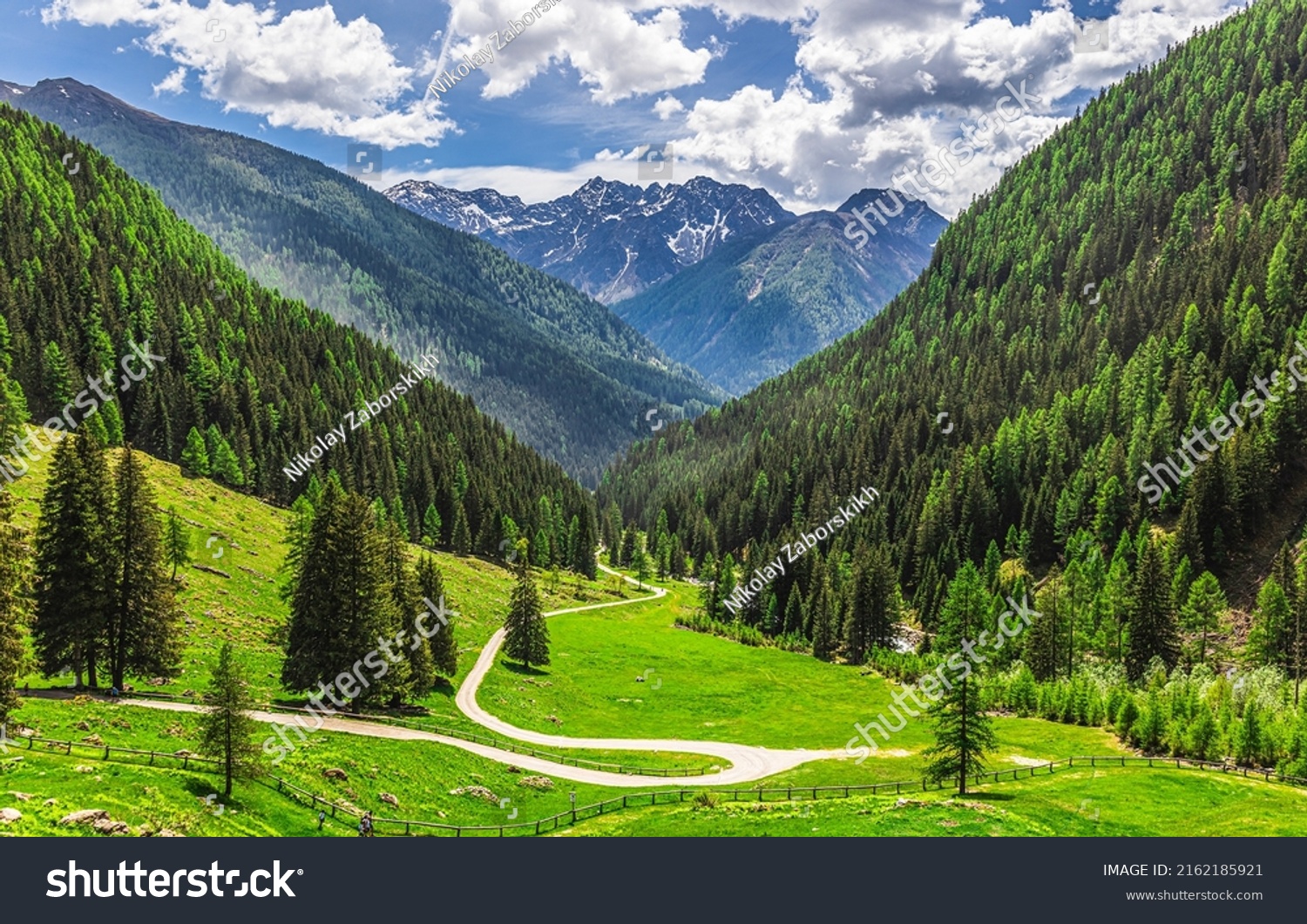 A winding path on a mountain slope. Mountain Alps path #2162185921