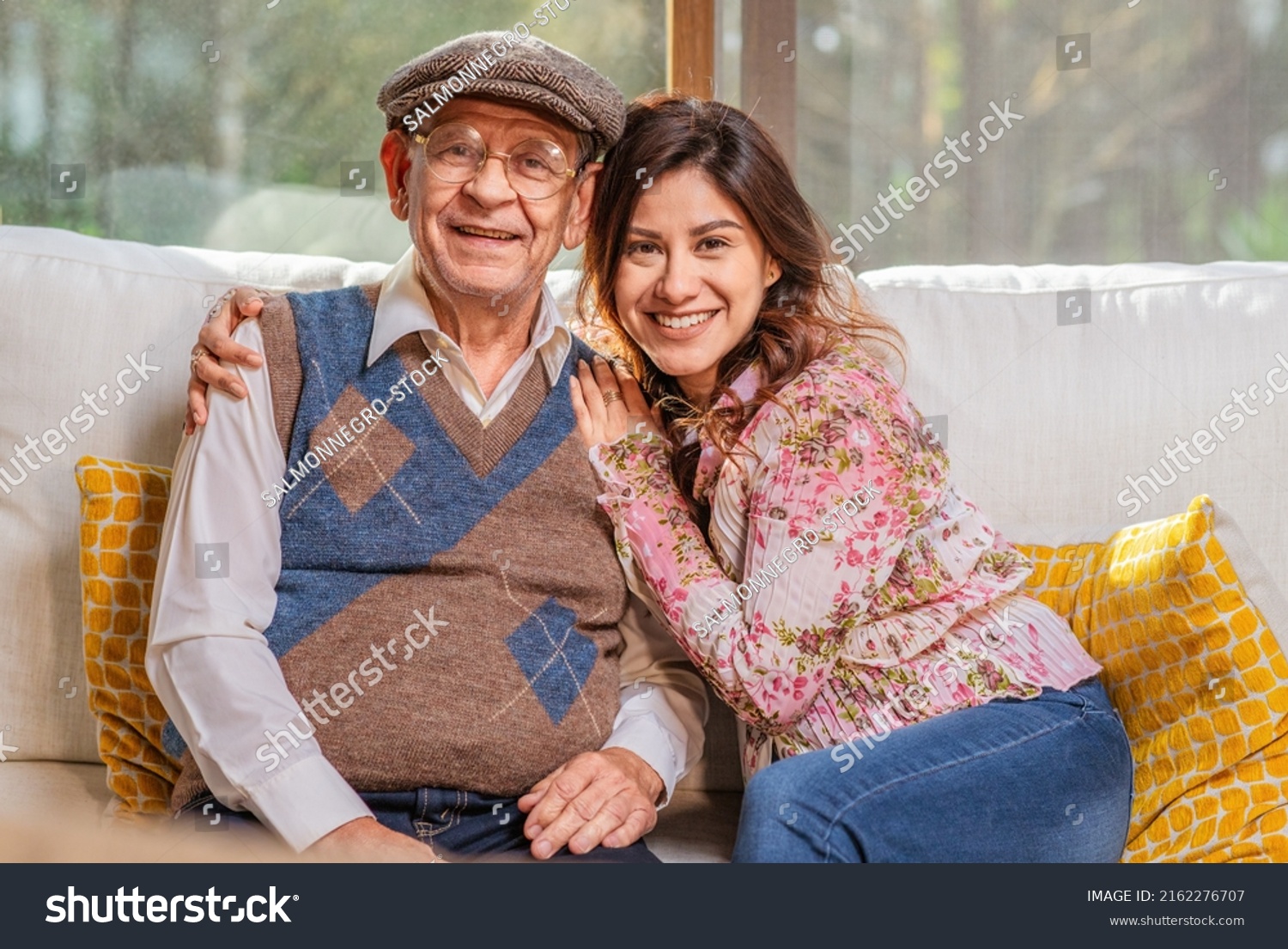 Portrait of beautiful Latin woman hugging her older father smiling and looking at camera. #2162276707