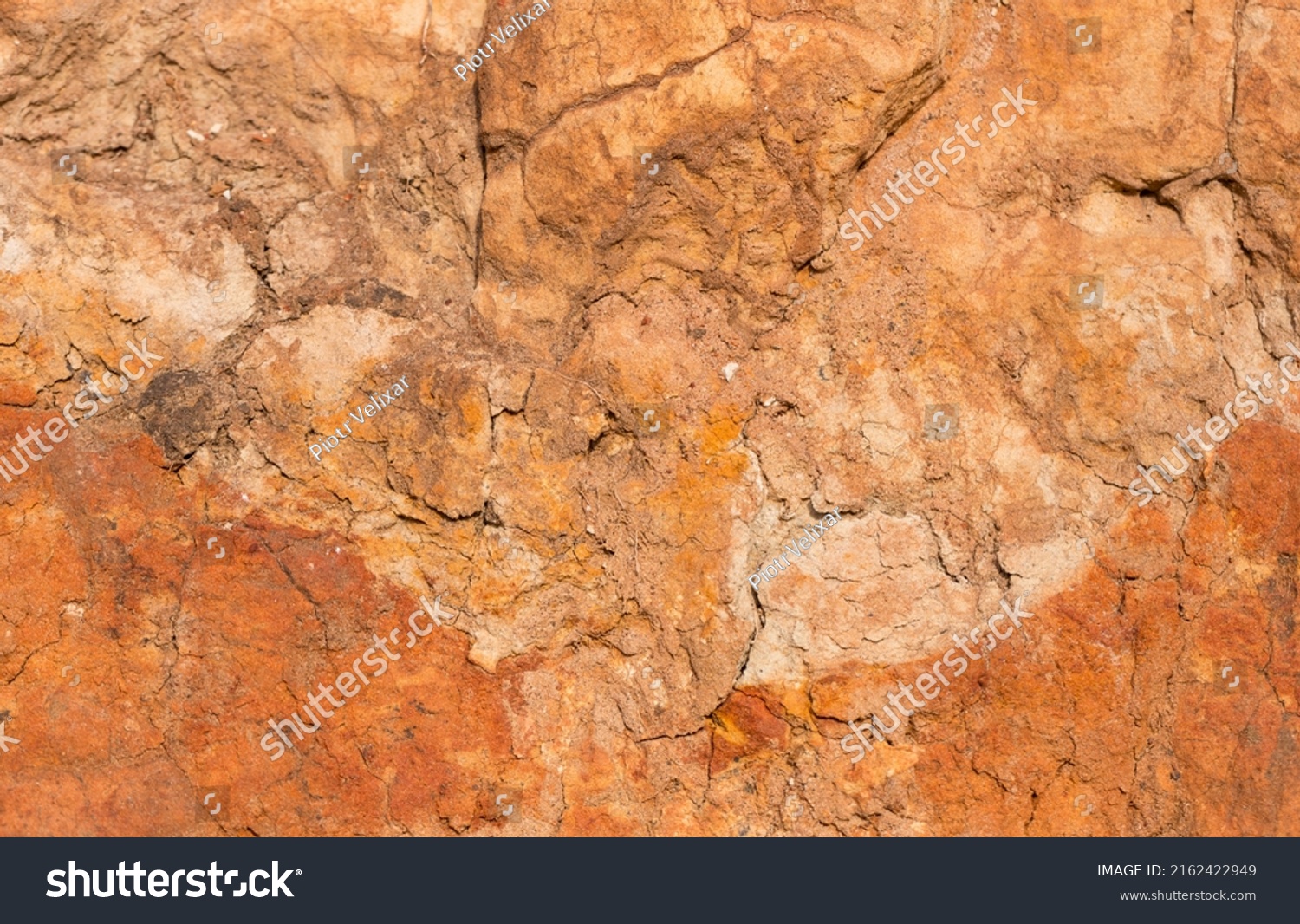 Sedimentary rocks with a high content of iron oxide. Red soil, loam. The texture of the soil. #2162422949