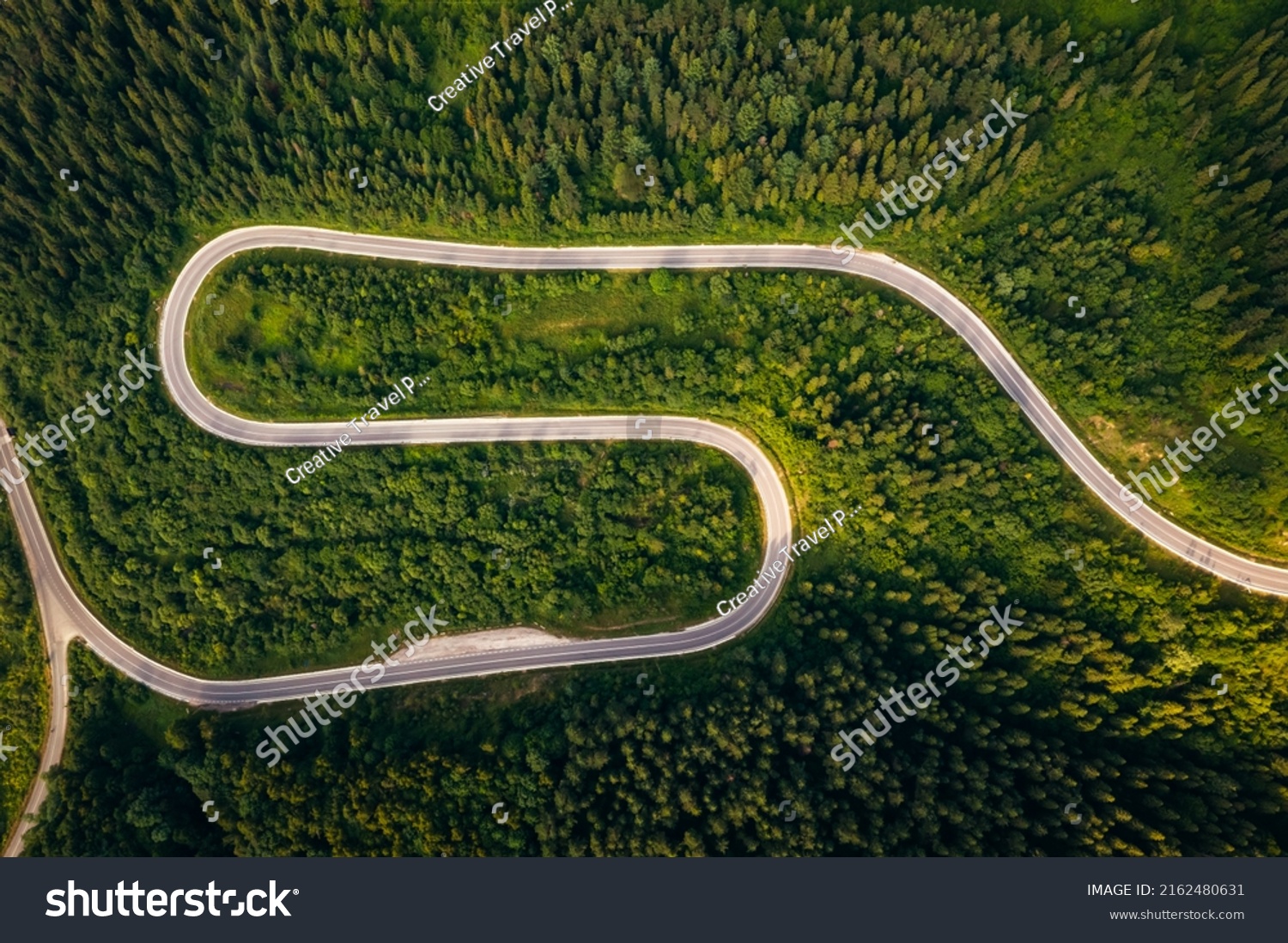 Bird's eye view from a drone flying over a winding road. Location place of Carpathians mountain, Ukraine, Europe. World landmarks. Photo wallpaper. Drone photography. Discover the beauty of earth. #2162480631