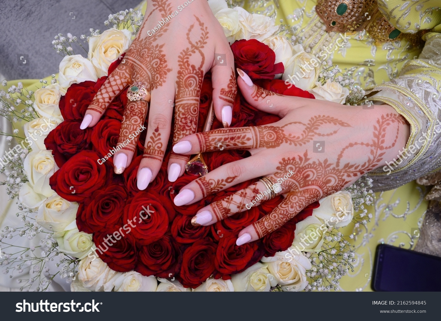 Henna Tattoo on Bride's Hand.Moroccan wedding preparation henna party. Temperate white mehndi. Modern mehendi art.

 #2162594845
