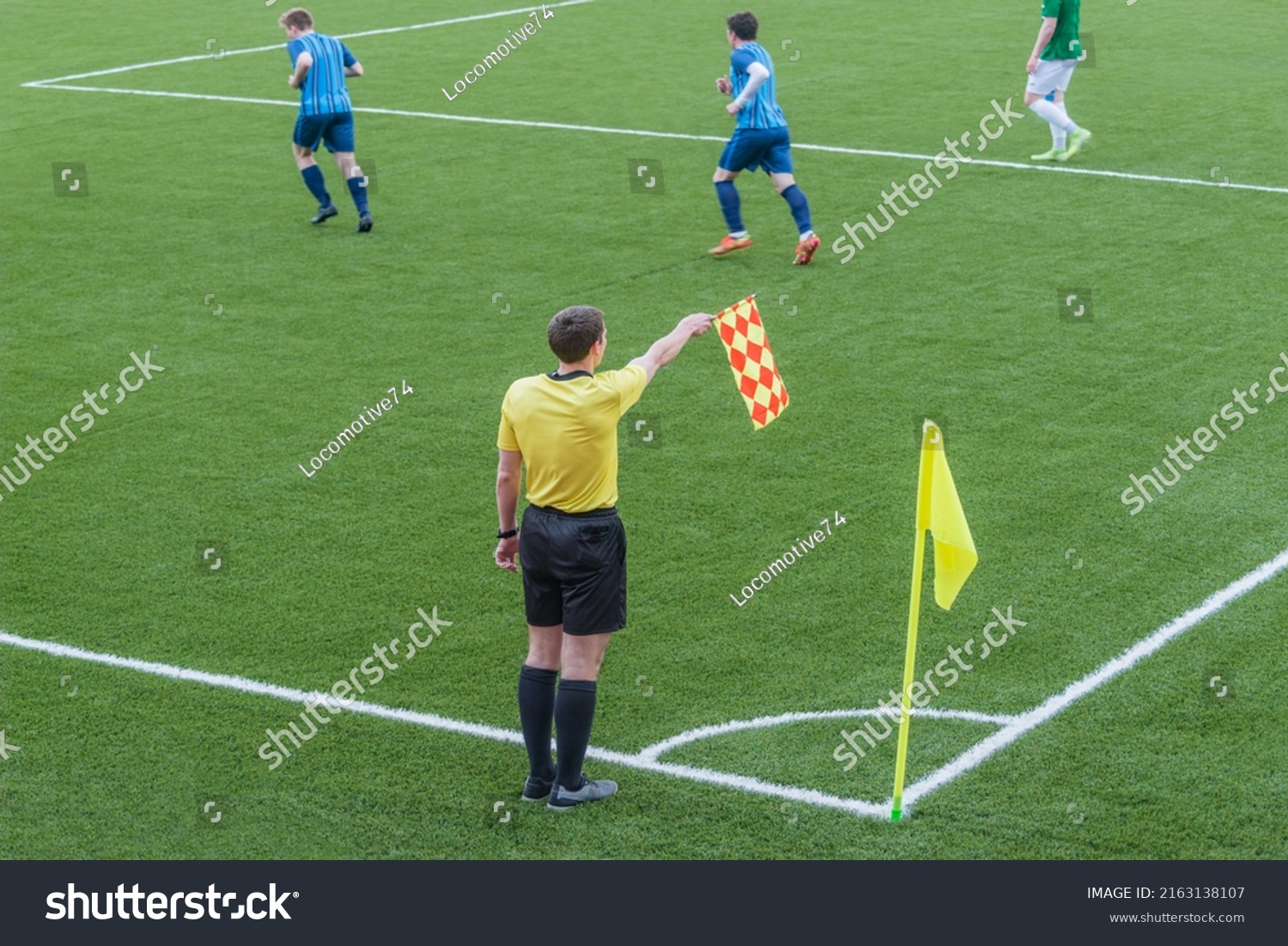 Referee from the sidelines of a soccer game. #2163138107