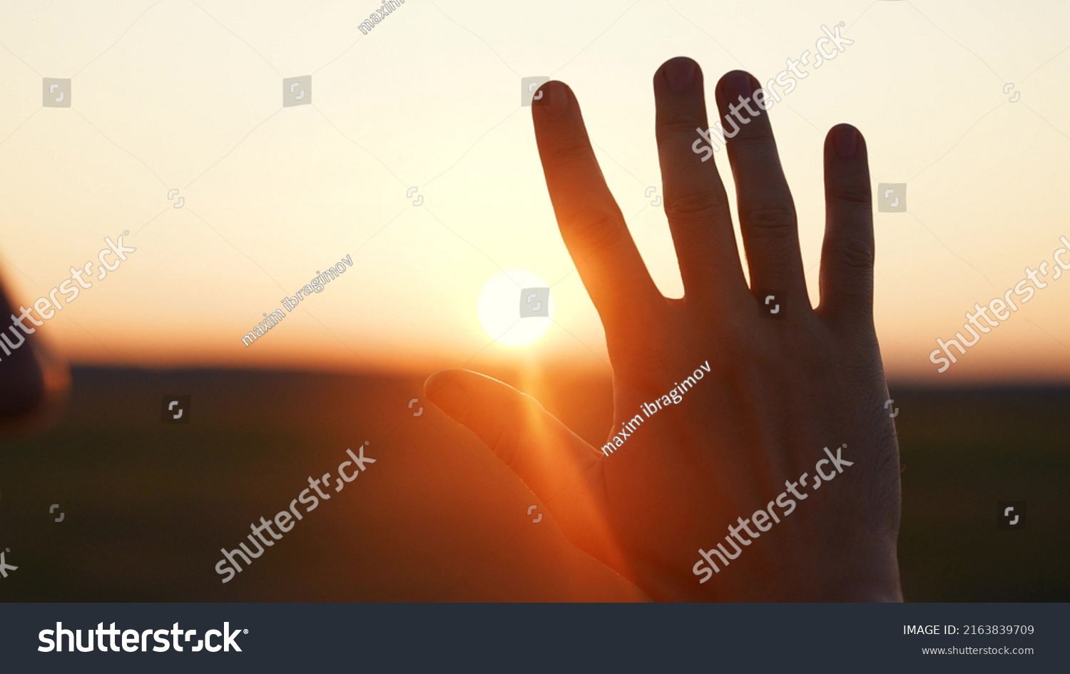 man hand silhouette sunlight. Muslim with man hand sun on light background. christian business love religion concept. christianity and religion belief in god. man sunlight hand reaches for sun god #2163839709