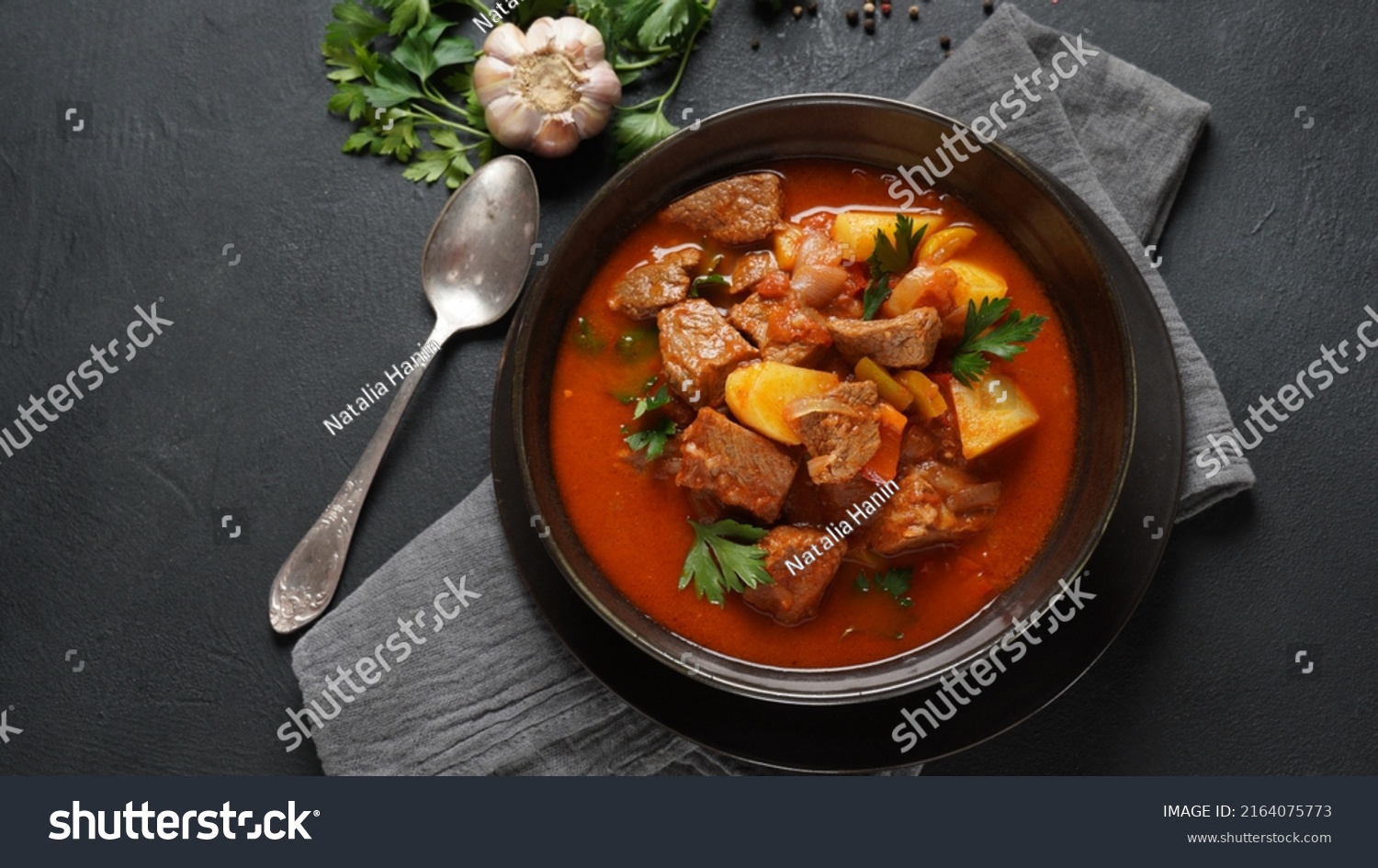 Beef goulash, soup and a stew, made of beef chuck steak, potatoes and plenty of paprika. Hungarian  traditional meal. #2164075773