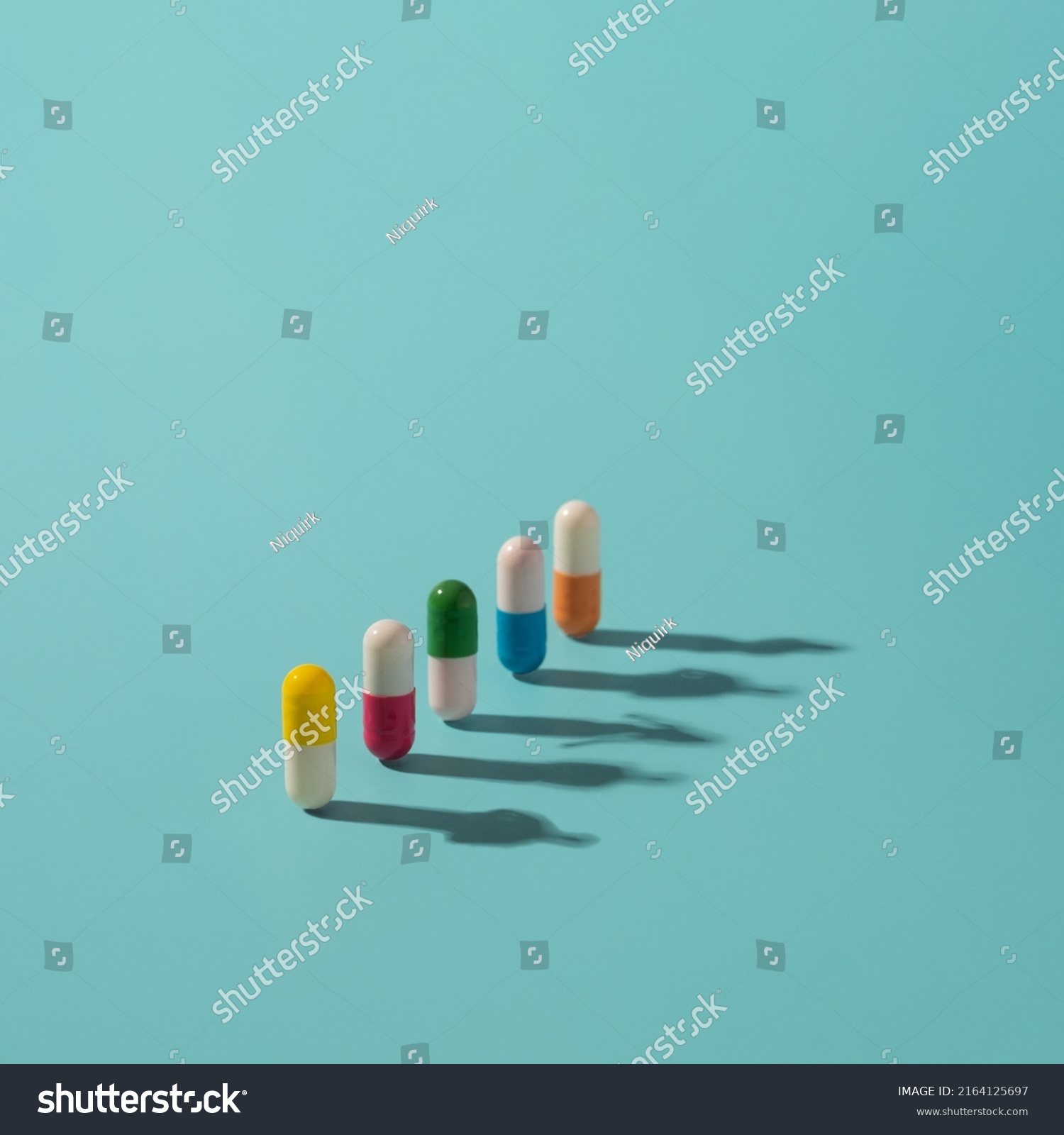 Medicine pills with colorful elements and human shadows on the surface. Health, drugs addiction conceptual background. #2164125697