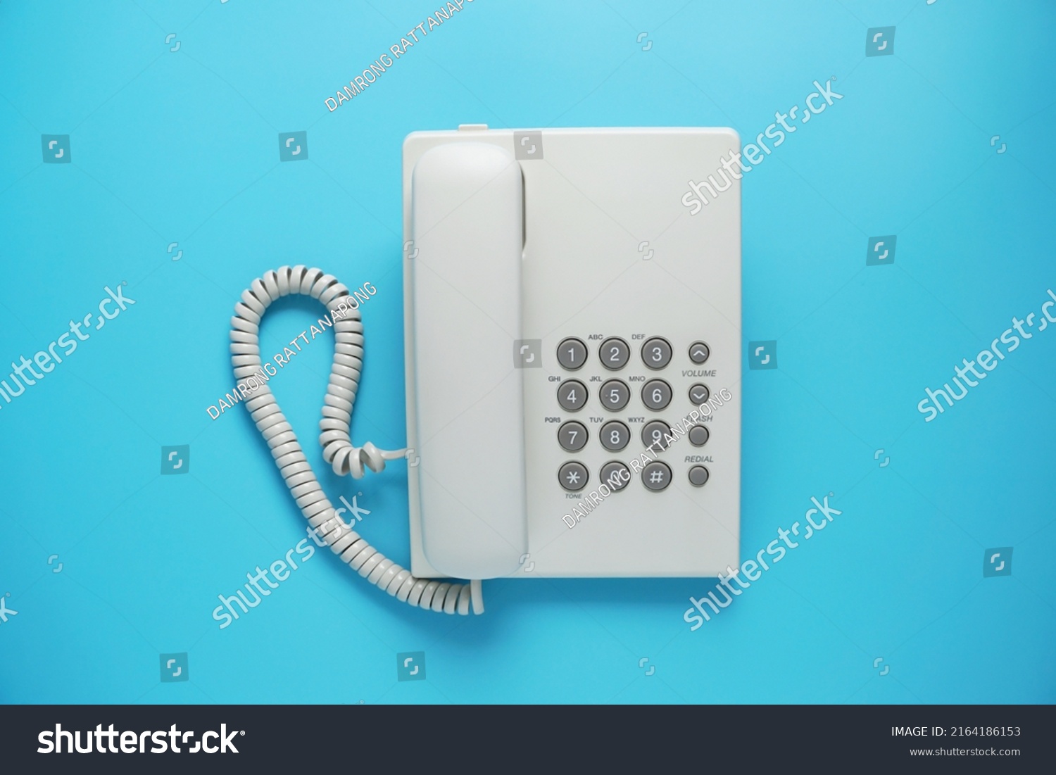 White landline telephone with grey buttons isolated on blue or pastel background #2164186153