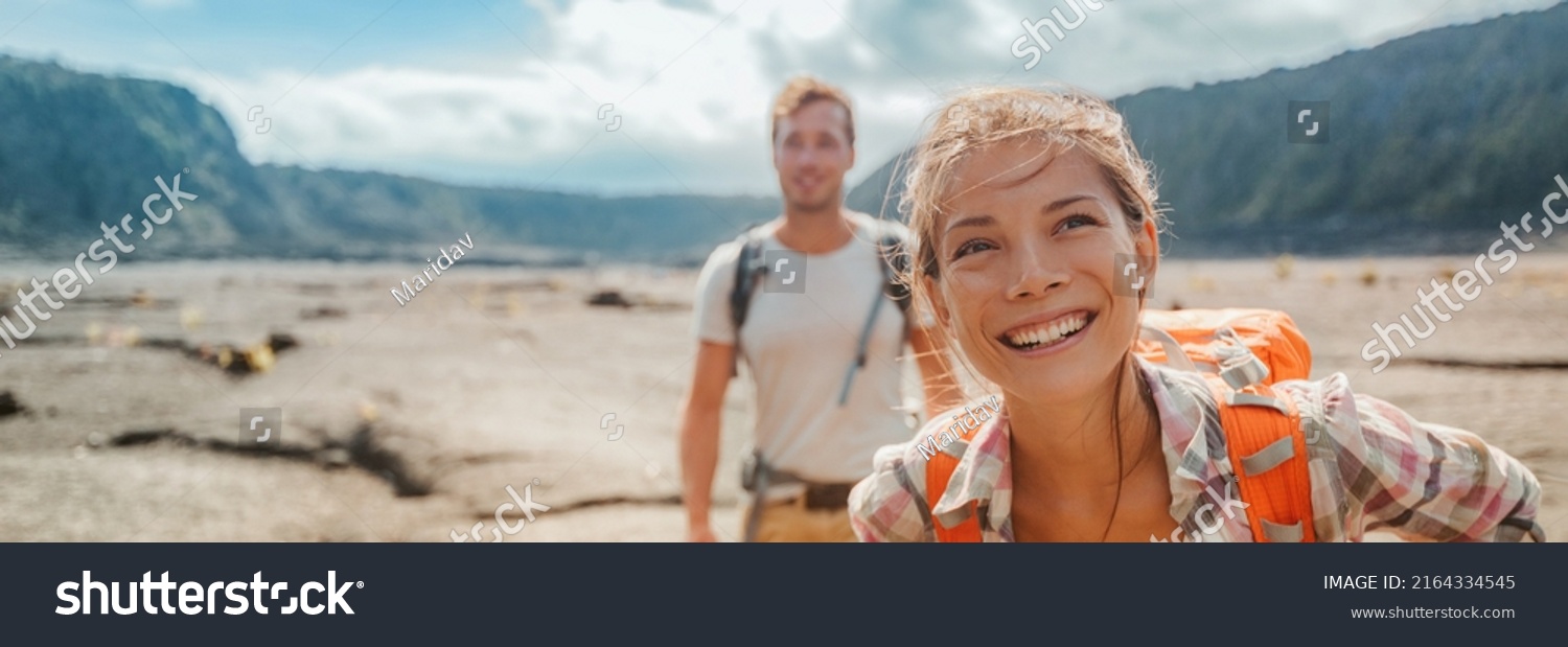 Travel hiking couple hikers happy with backpacks on summer outdoor active adventure vacation. Smiling Asian girl and man hikers banner landscape panoramic #2164334545
