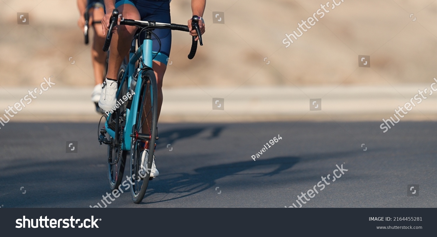 Cycling competition, cyclist athletes riding a race at high speed. Cycling sport triathletes womens biking on triathlon bike #2164455281