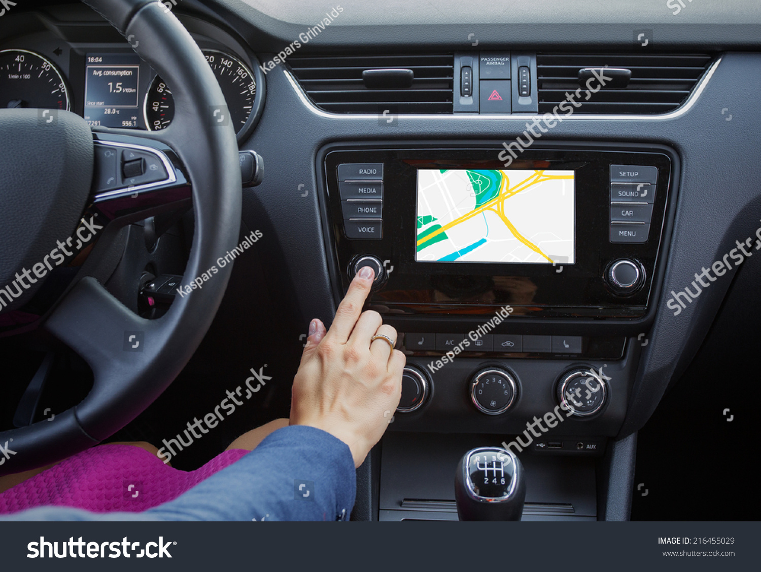 Woman using navigation system while driving a car #216455029