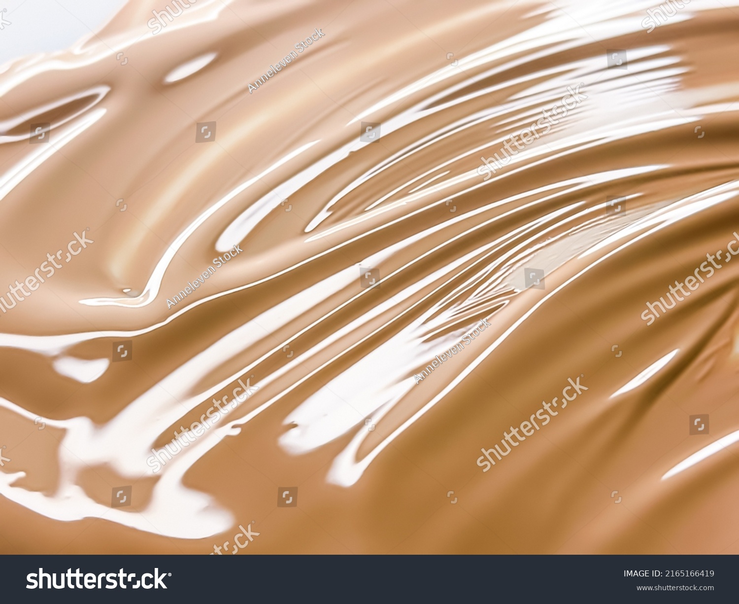 Glossy cosmetic texture, beige liquid foundation or concealer as beauty make-up product background, skincare cosmetics and luxury makeup brand design concept #2165166419