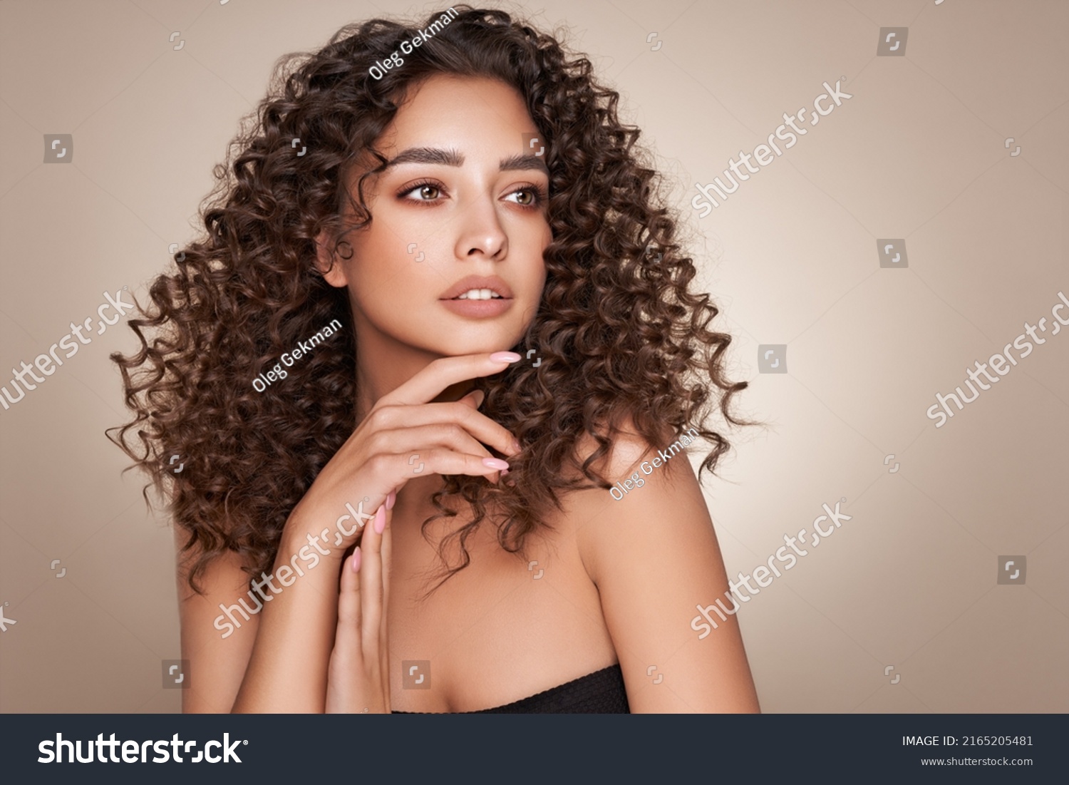 Fashion studio portrait of beautiful smiling woman with afro curls hairstyle. Fashion and beauty #2165205481