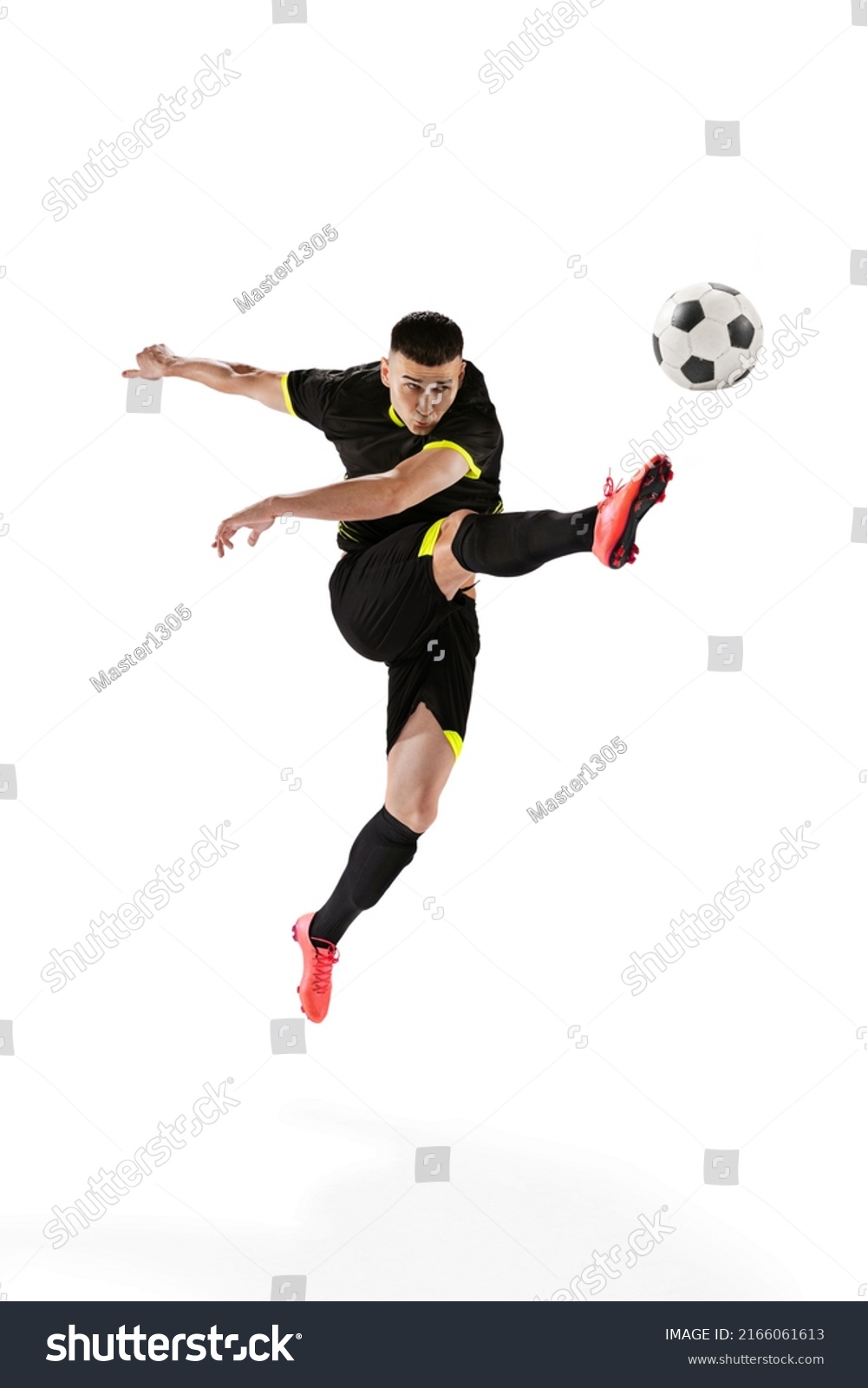 Professional male football soccer player in motion and action isolated on white studio background. Concept of sport, goals, competition, hobby, ad, world cup. Sportsmen wearing black football kit #2166061613
