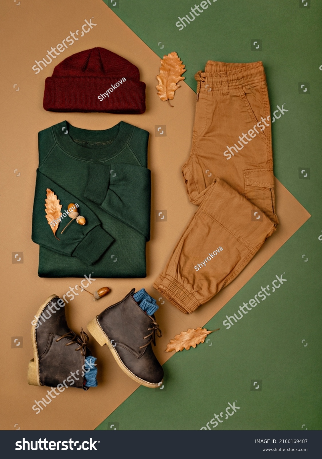 Composition of toddler boy warm clothes, shoes and a toy on color background. Children's clothes for autumn. Kids fashion outfit. Winter, autumn collection. Organic cotton. Top view, flat lay. #2166169487