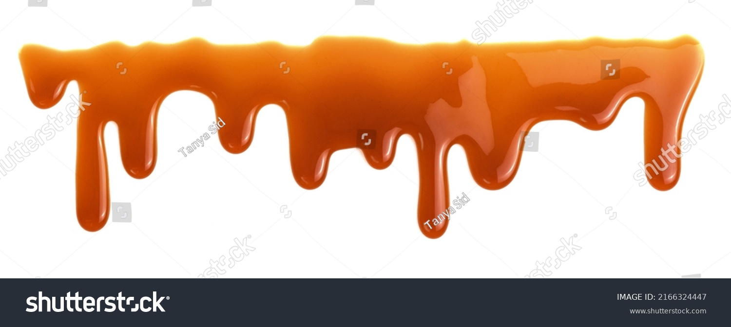 Dripping caramel drops of sweet sauce isolated on white background. Melted caramel sauce #2166324447