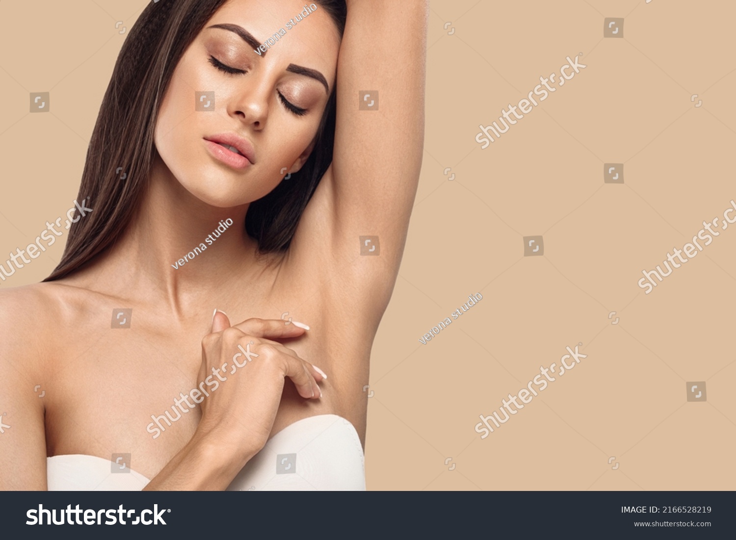 Armpit epilation, lacer hair removal. Young woman holding her arms up and showing clean underarms, depilation smooth clear skin .Beauty portrait #2166528219
