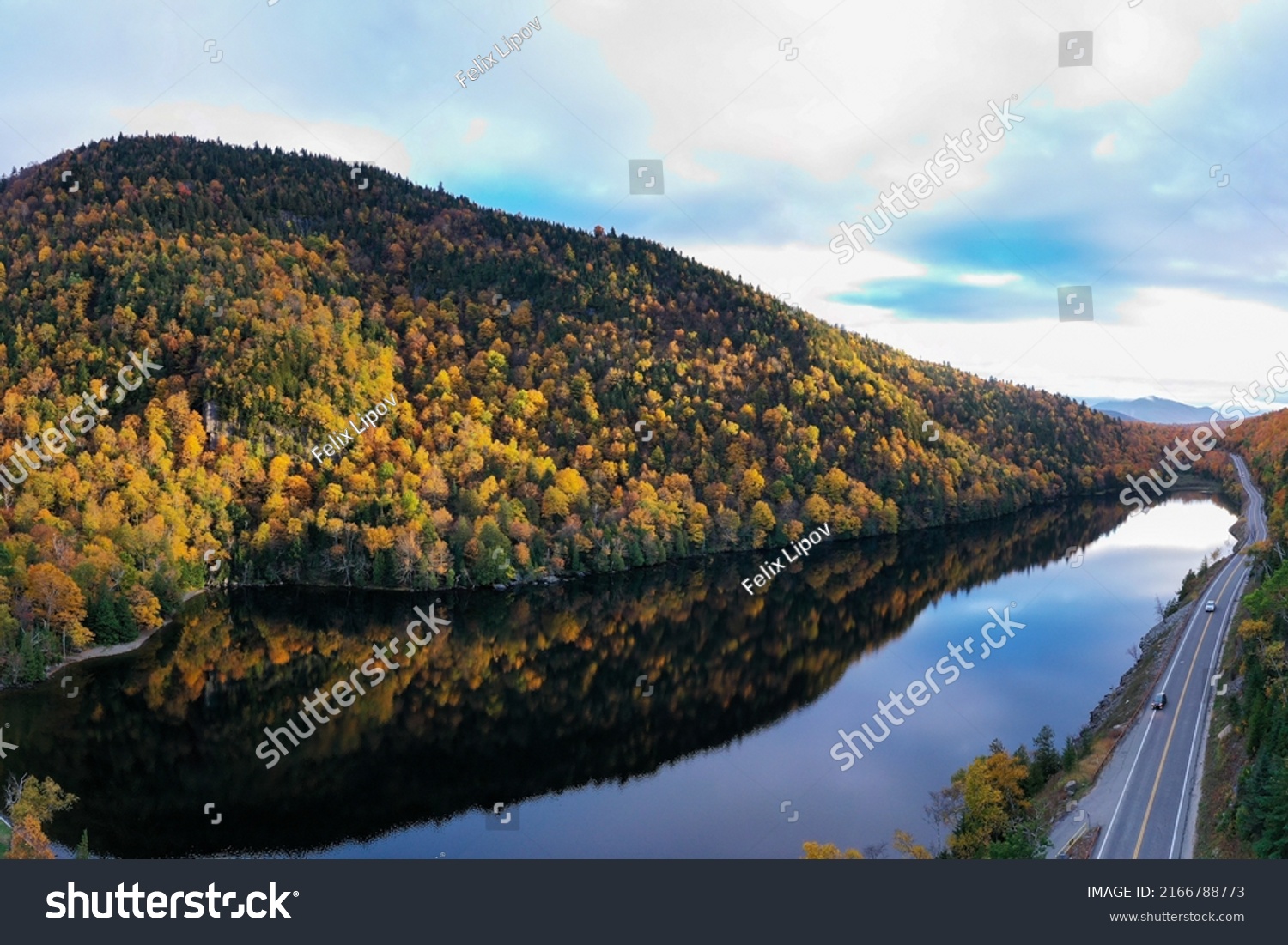 Peak fall foliage in Keene, New York by Cascade Lake. #2166788773