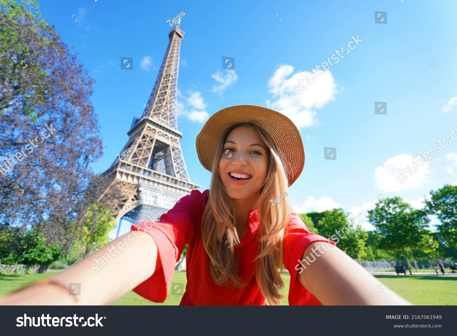 Selfie girl in Paris, France. Young tourist woman taking self portrait with Eiffel Tower in Paris. #2167061949