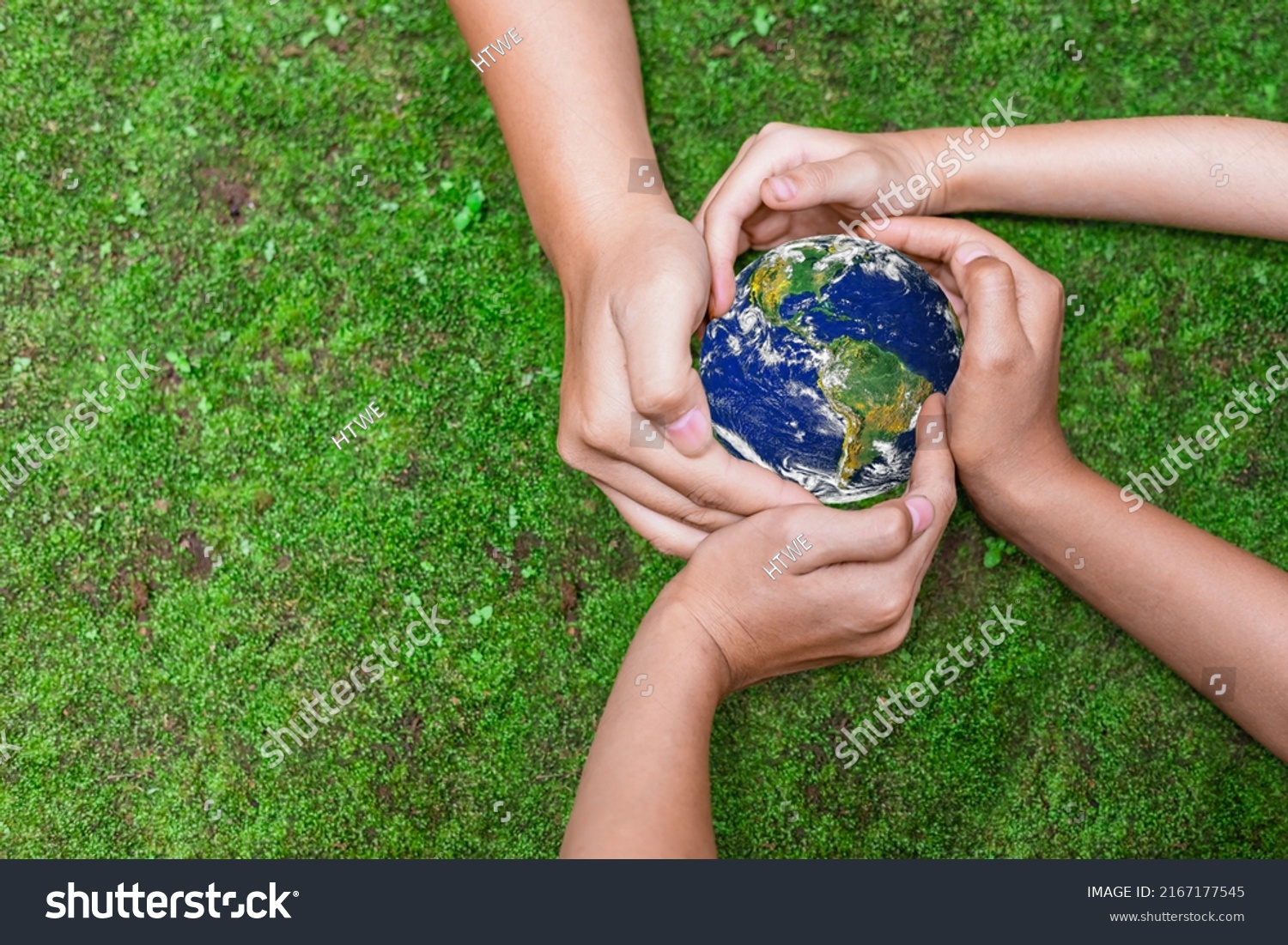 Environment conservation concept. Young children hands holding globe on green nature background for sustainable development goal.  world image by NASA #2167177545
