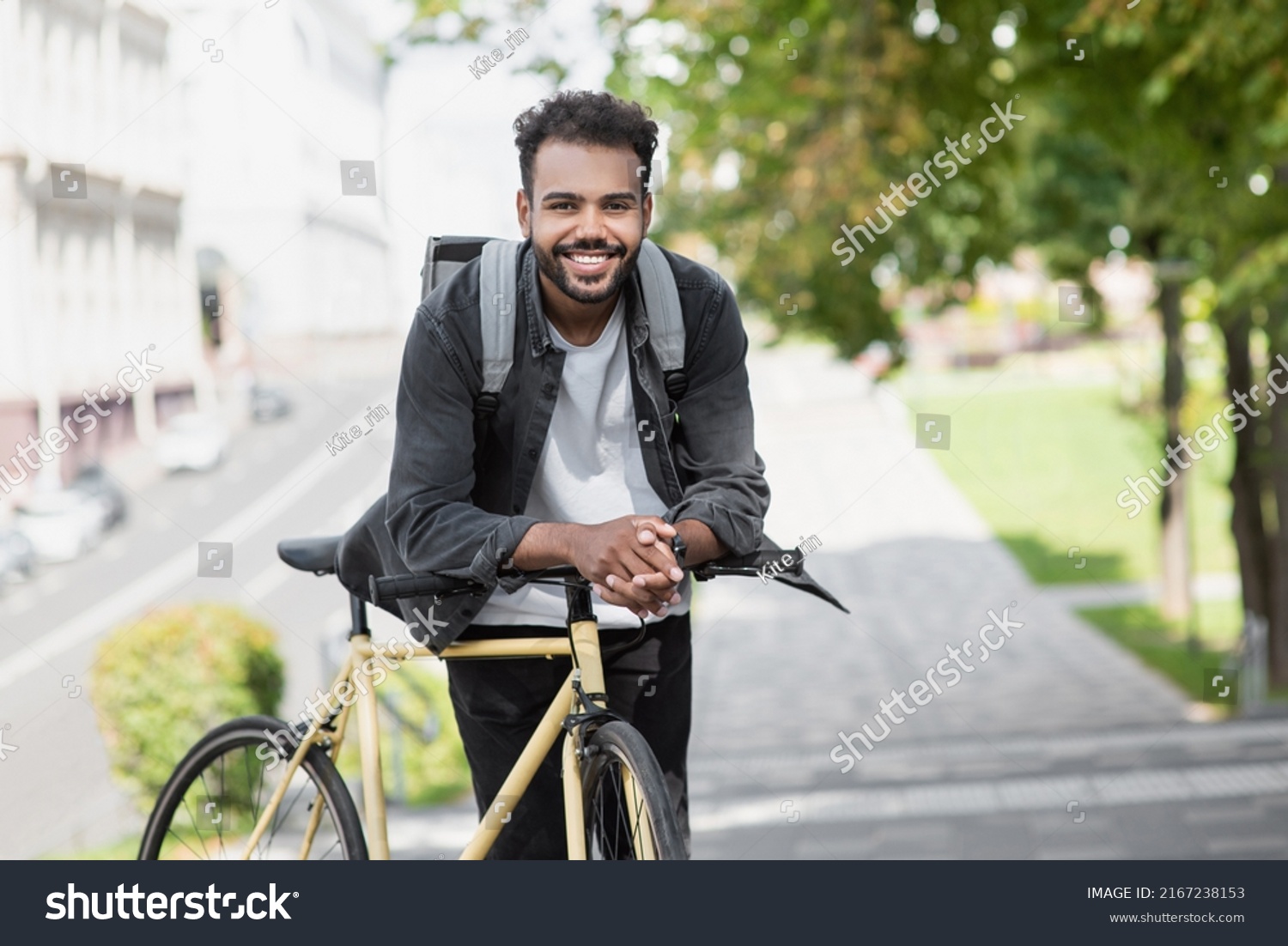 Handsome happy young man with bicycle on a city street, Active lifestyle, people concept #2167238153