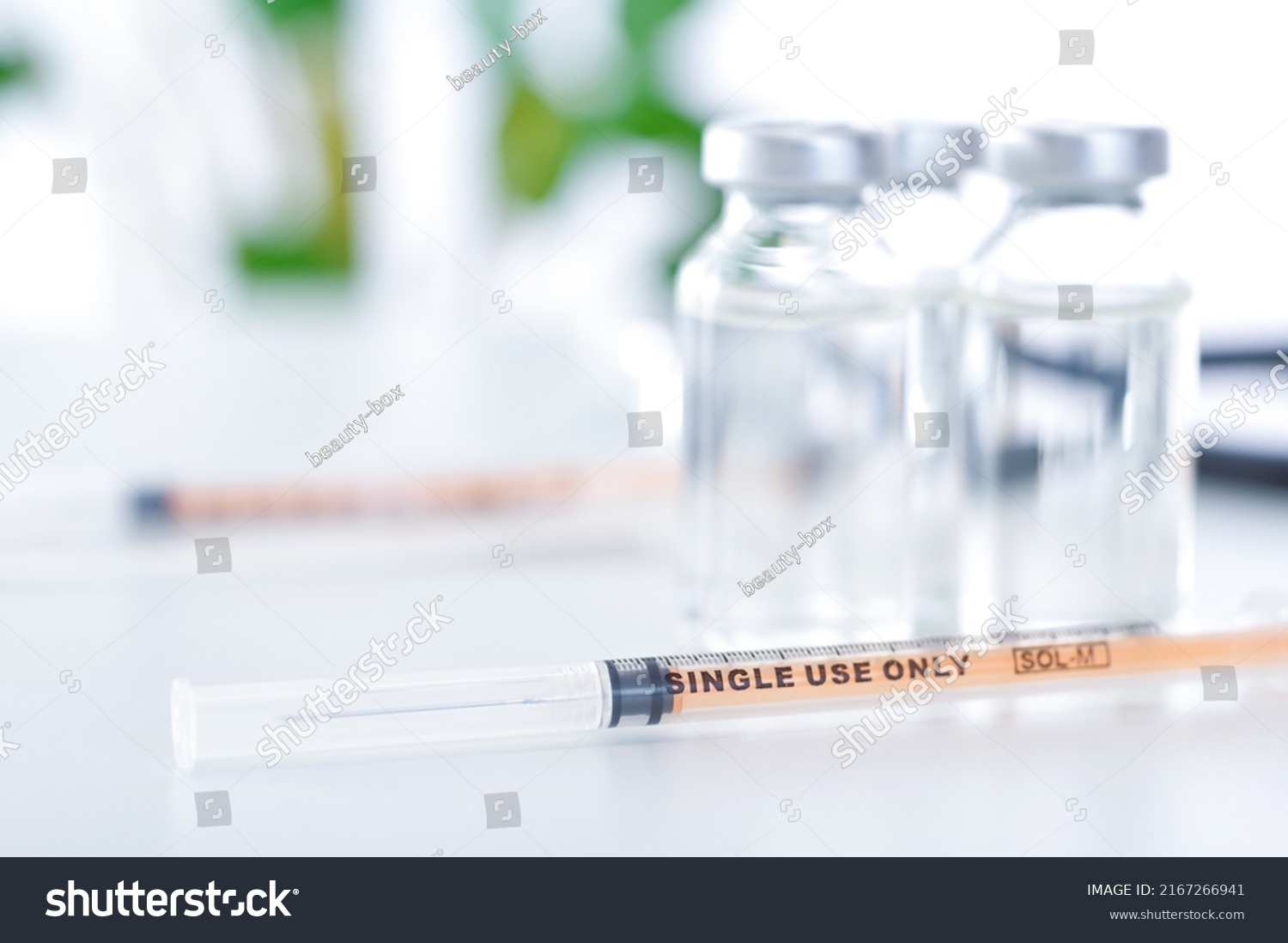 Vial jars and syringes placed on a clean table #2167266941
