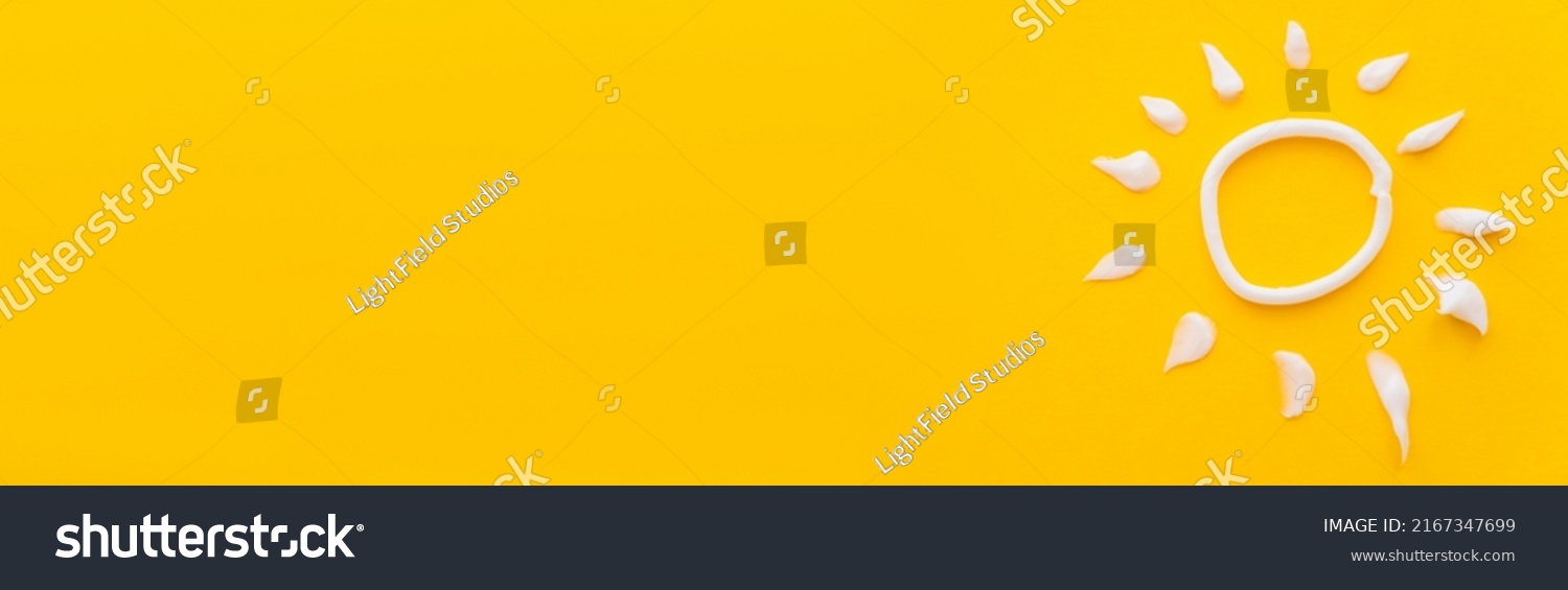 Top view of white sun sign from sunscreen cream on yellow background, banner #2167347699