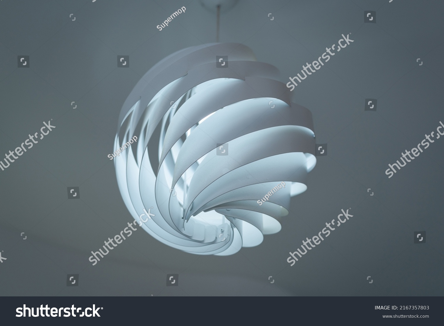 Modern ceiling lamps and light bulbs ball shape decoration for home and living from the plastic sheet sphere spiral shape geometry pattern. Concept interior building contemporary. #2167357803