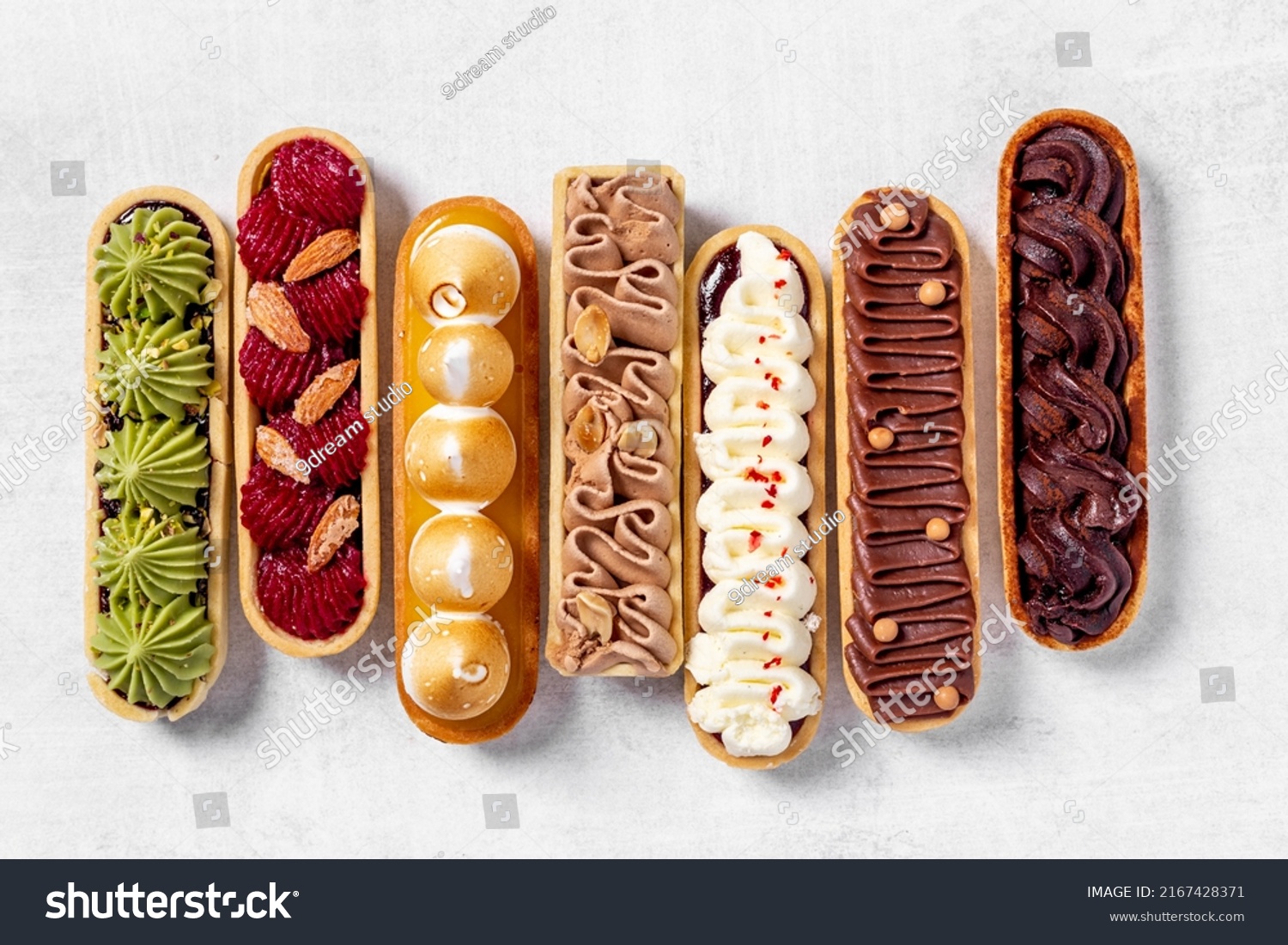 Set of delicious dessert eclairs with colorful topping #2167428371