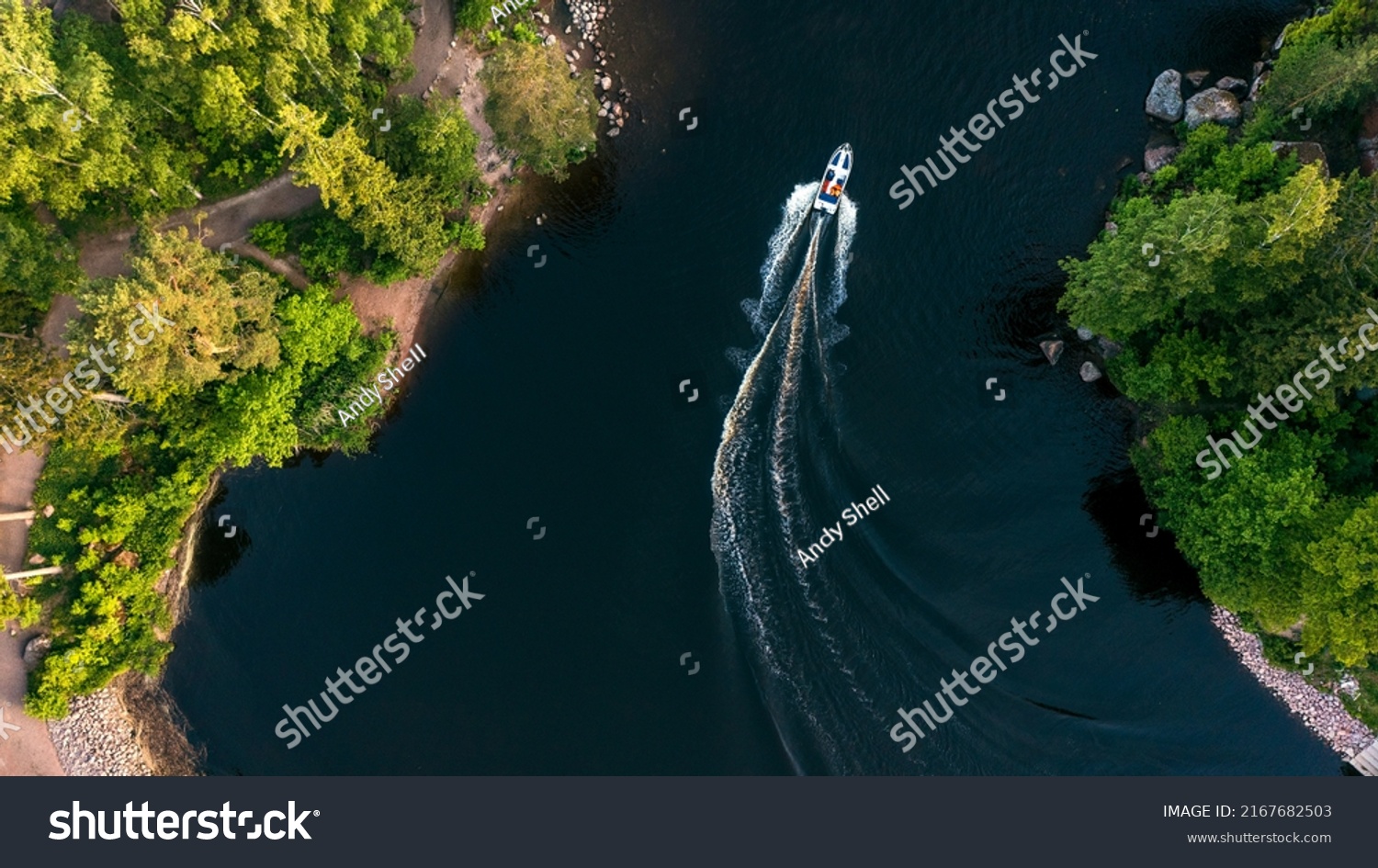 Top view of a white boat sailing in the blue sea. Top view of the boat. Aerial view luxury motor boat. A boat with a motor on blue water. High quality photo #2167682503