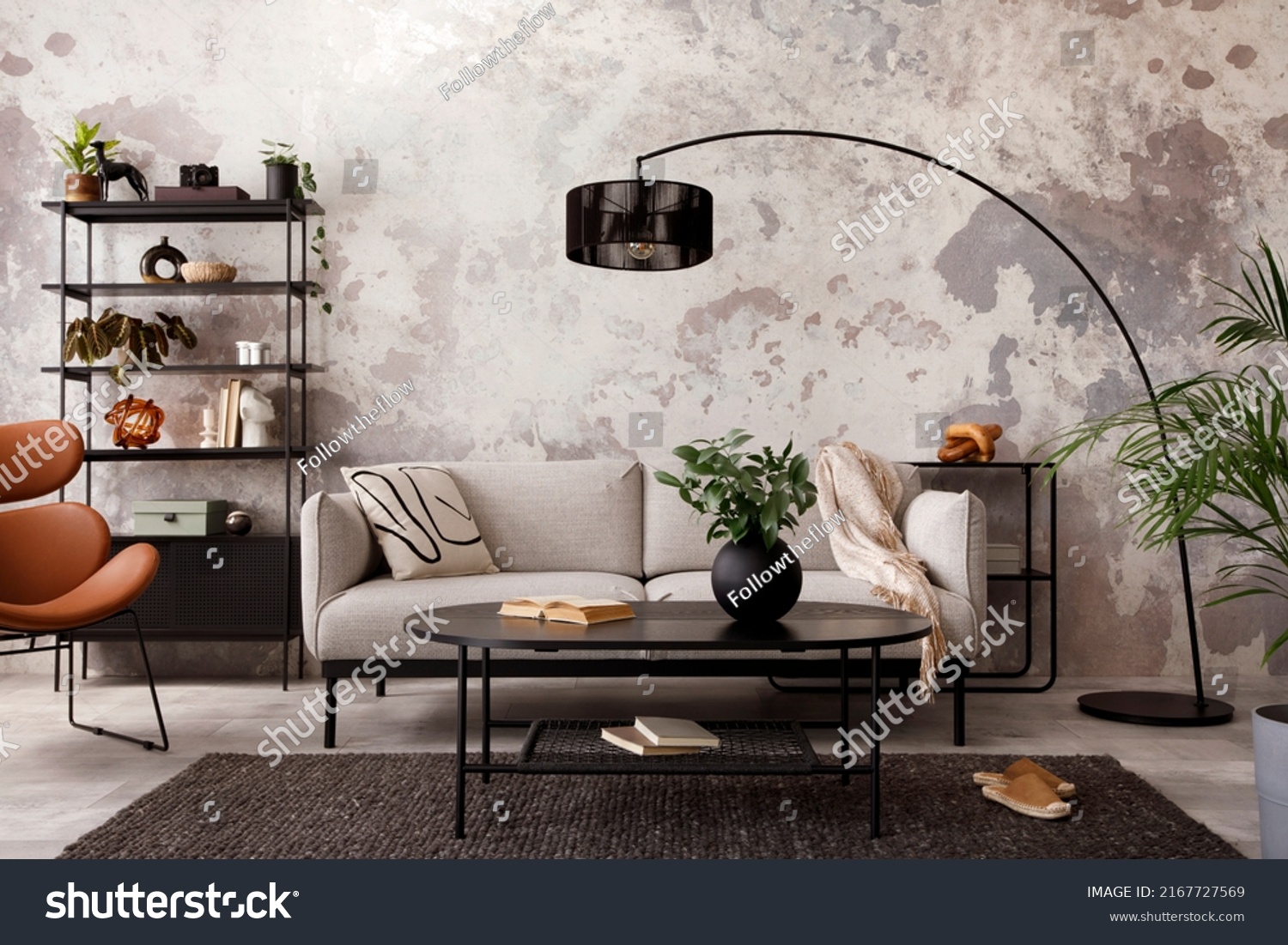The stylish compostion at living room interior with design gray sofa, armchair, black coffee table, lamp and elegant personal accessories. Loft and industrial interior. Template. 
 #2167727569