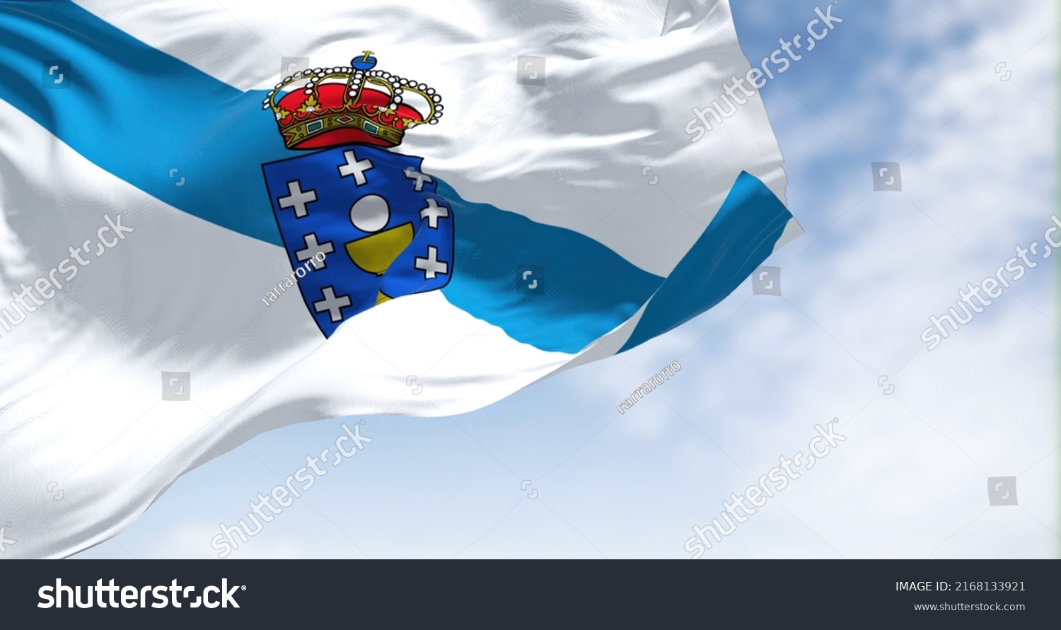 The Galicia flag waving in the wind on a clear day. Galicia is an autonomous community of Spain and historic nationality under Spanish law #2168133921