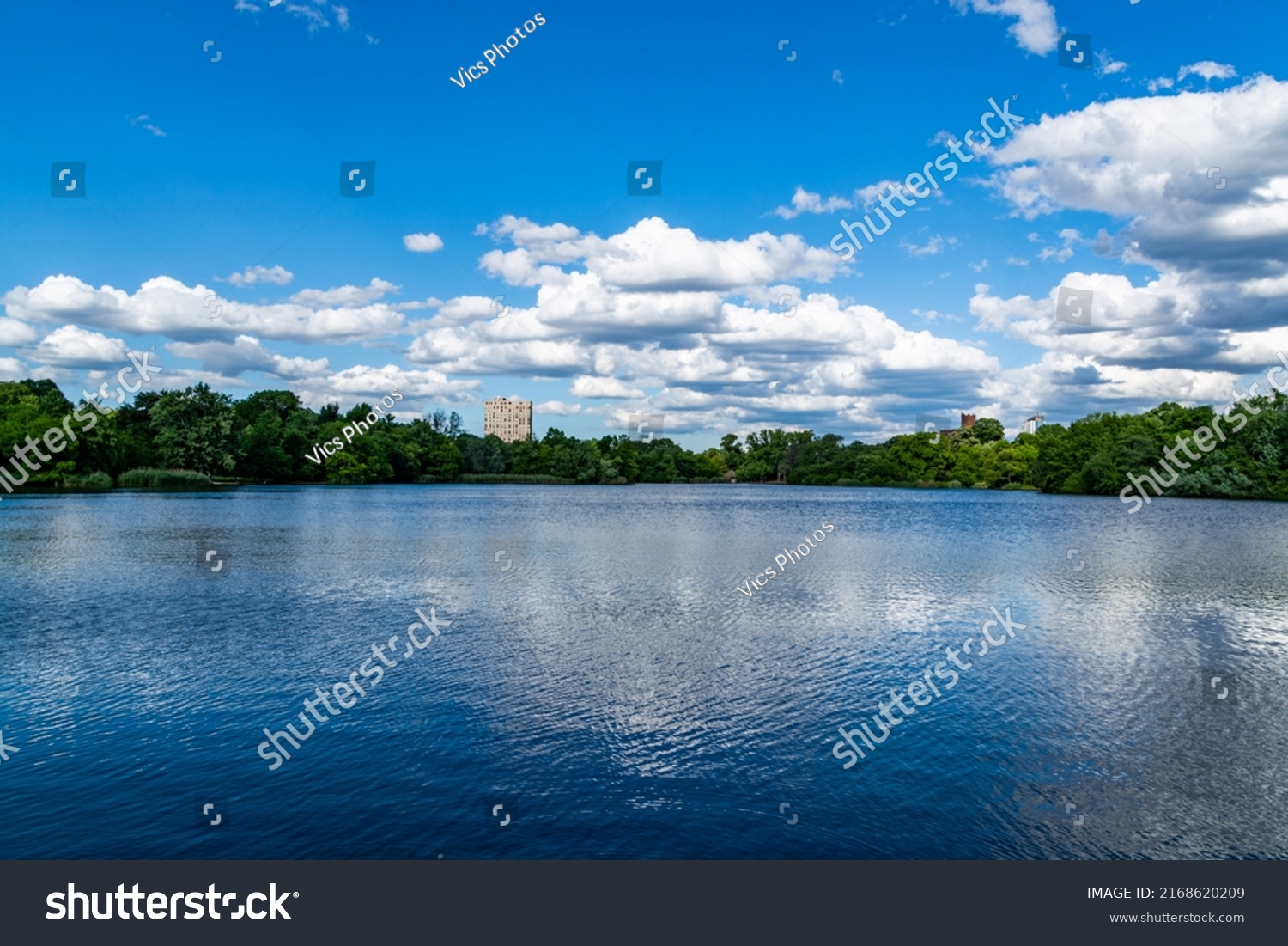 Lake view in the park, blue sky and clouds #2168620209