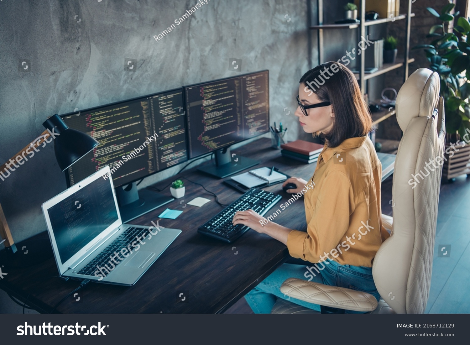 Profile side view portrait of attractive focused skilled girl web developer using laptop at workplace workstation indoors #2168712129